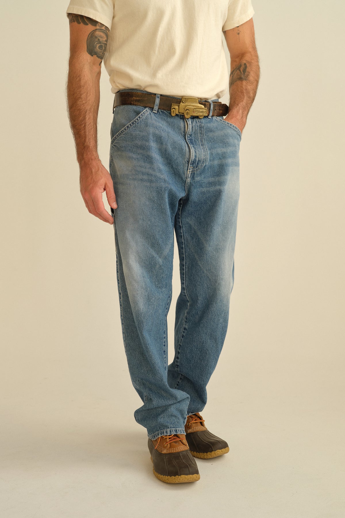 Light blue denim painter trousers with belt loops, front seams, and straight fit