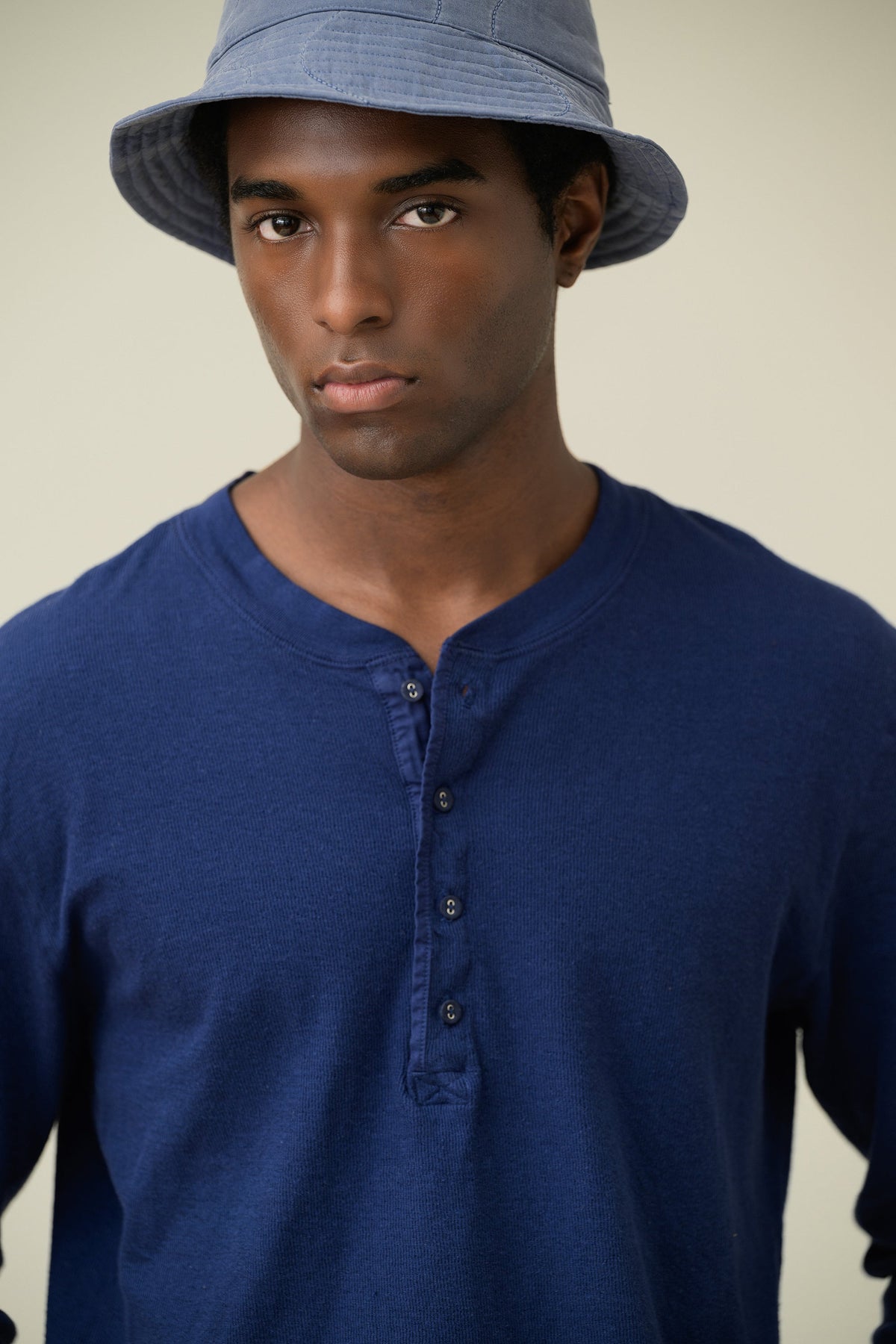 Blue long-sleeve henley shirt close-up with three-button placket