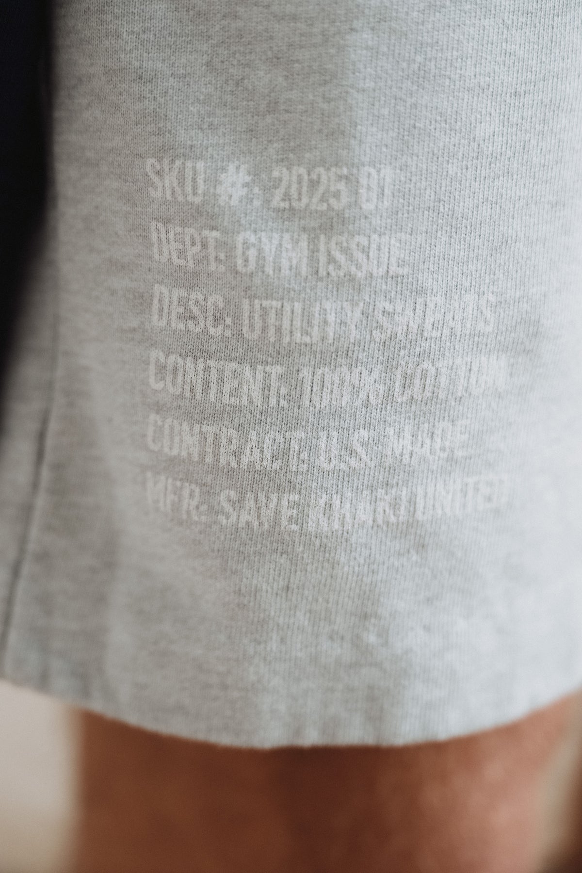 Heather grey terry fabric with printed text near the hem