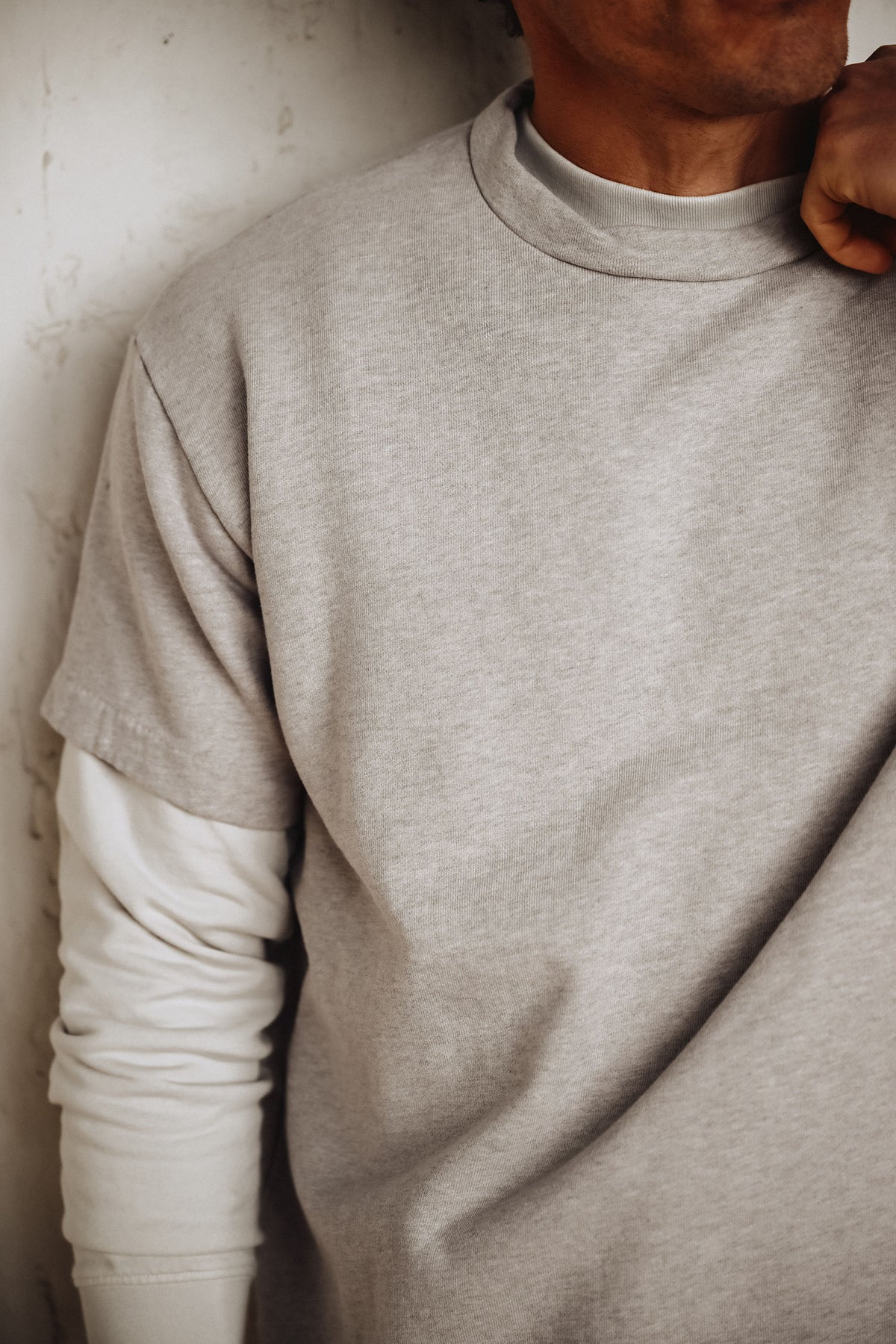 Men’s heather grey crewneck T-shirt with visible left sleeve and neckline