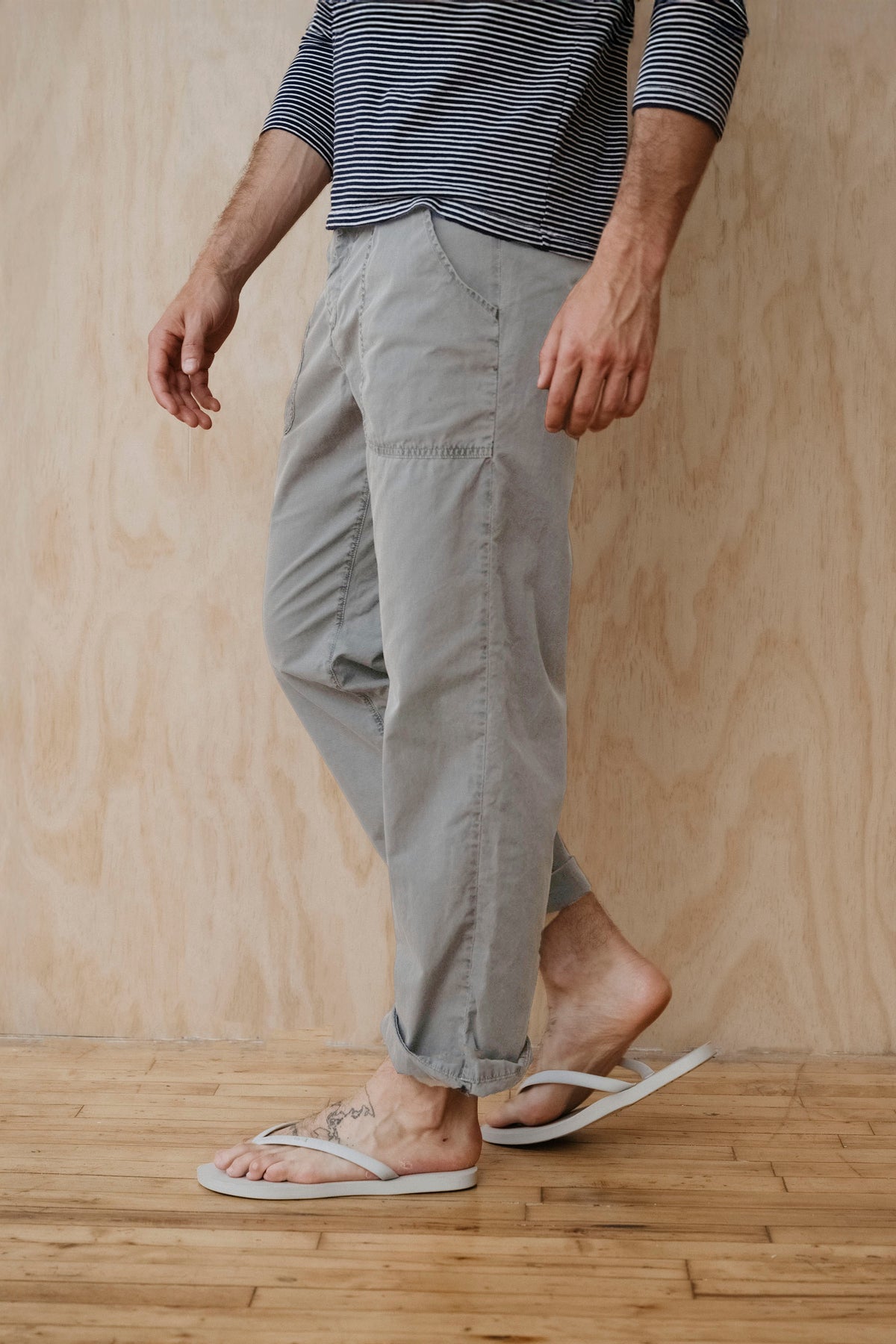 Light gray poplin supply pants on model with elastic waistband and cuffed hem
