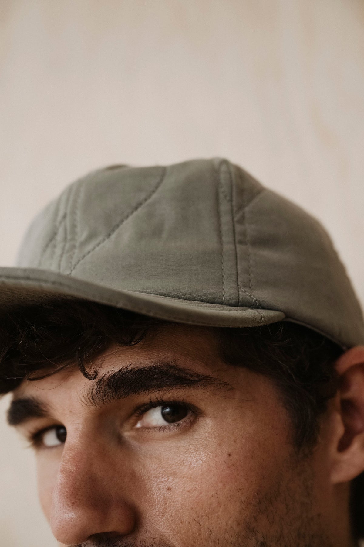 Quilted baseball hat in light gray with curved brim and side panel stitching