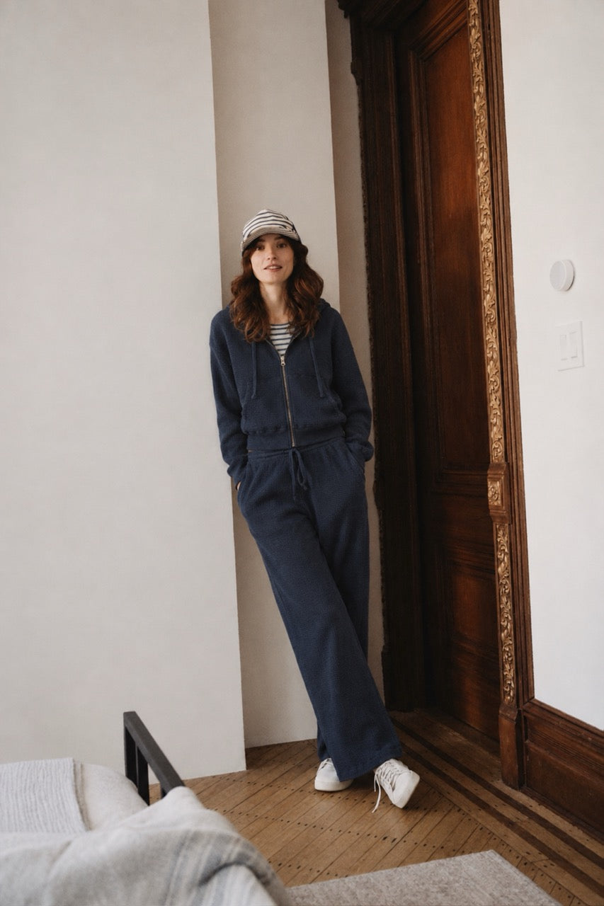 Navy zip-front crop hoodie with hood and drawstring ties, full outfit view