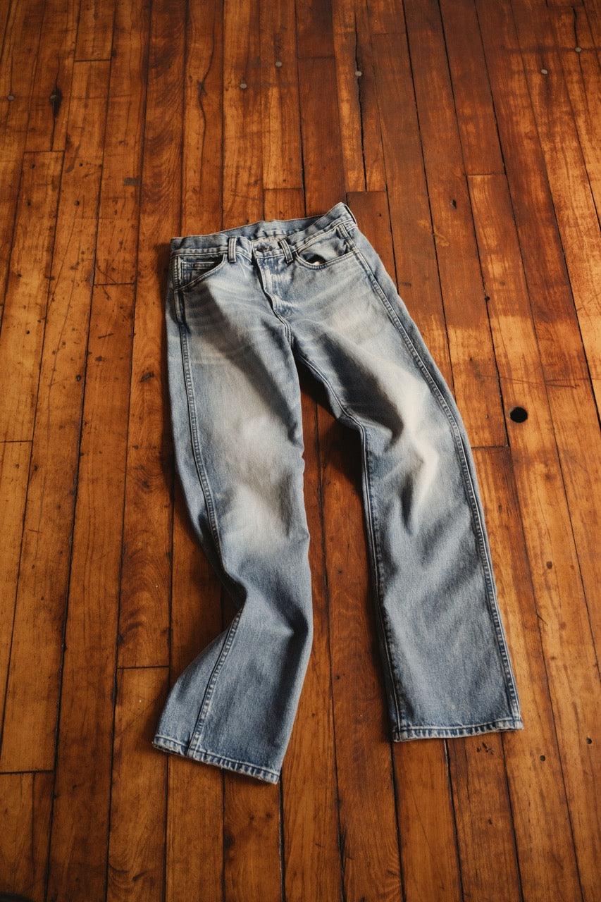 Light wash denim jeans laid flat