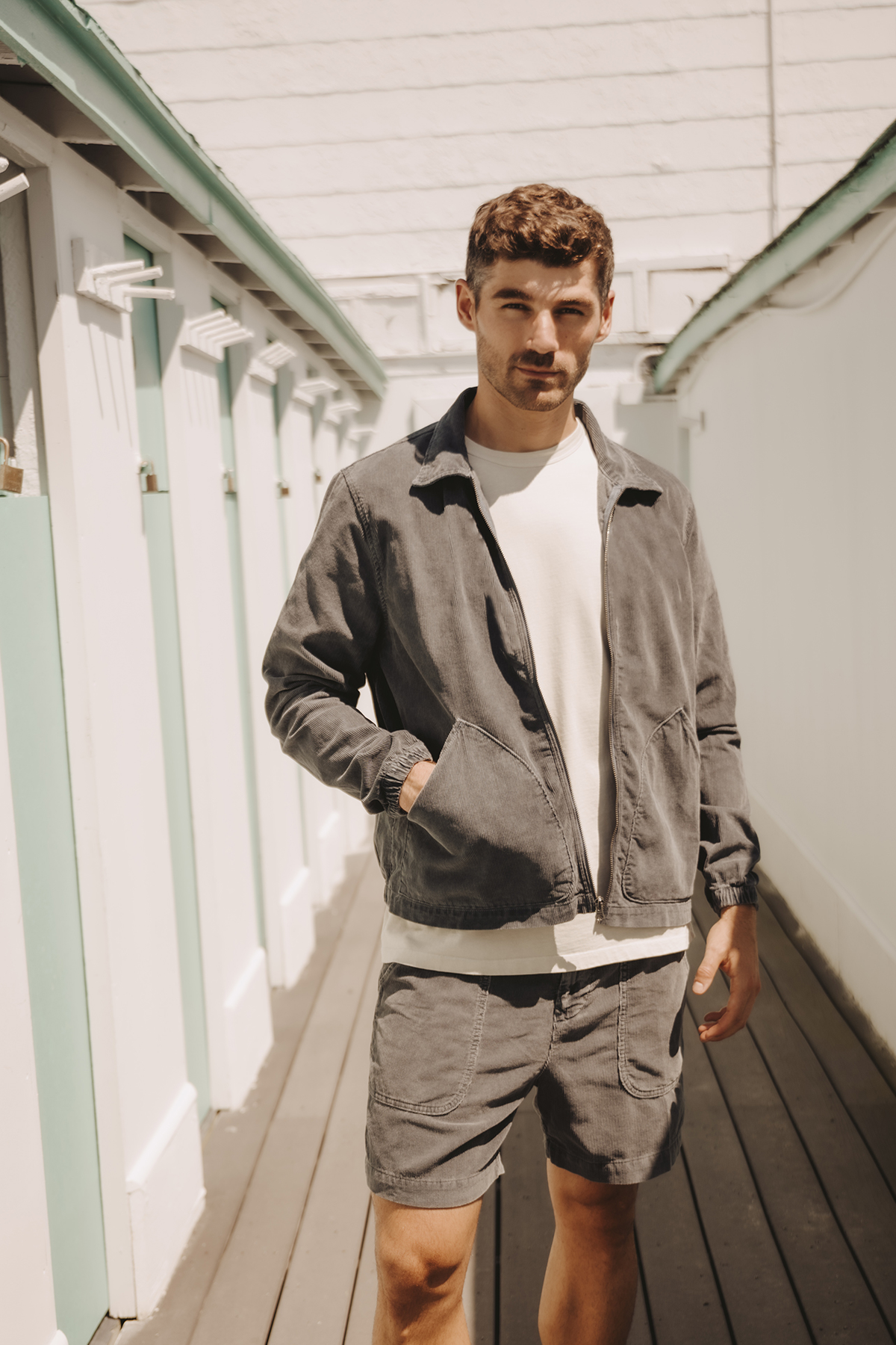 Cord Easy jacket on model, dark charcoal zip-up with chest pockets and long sleeves