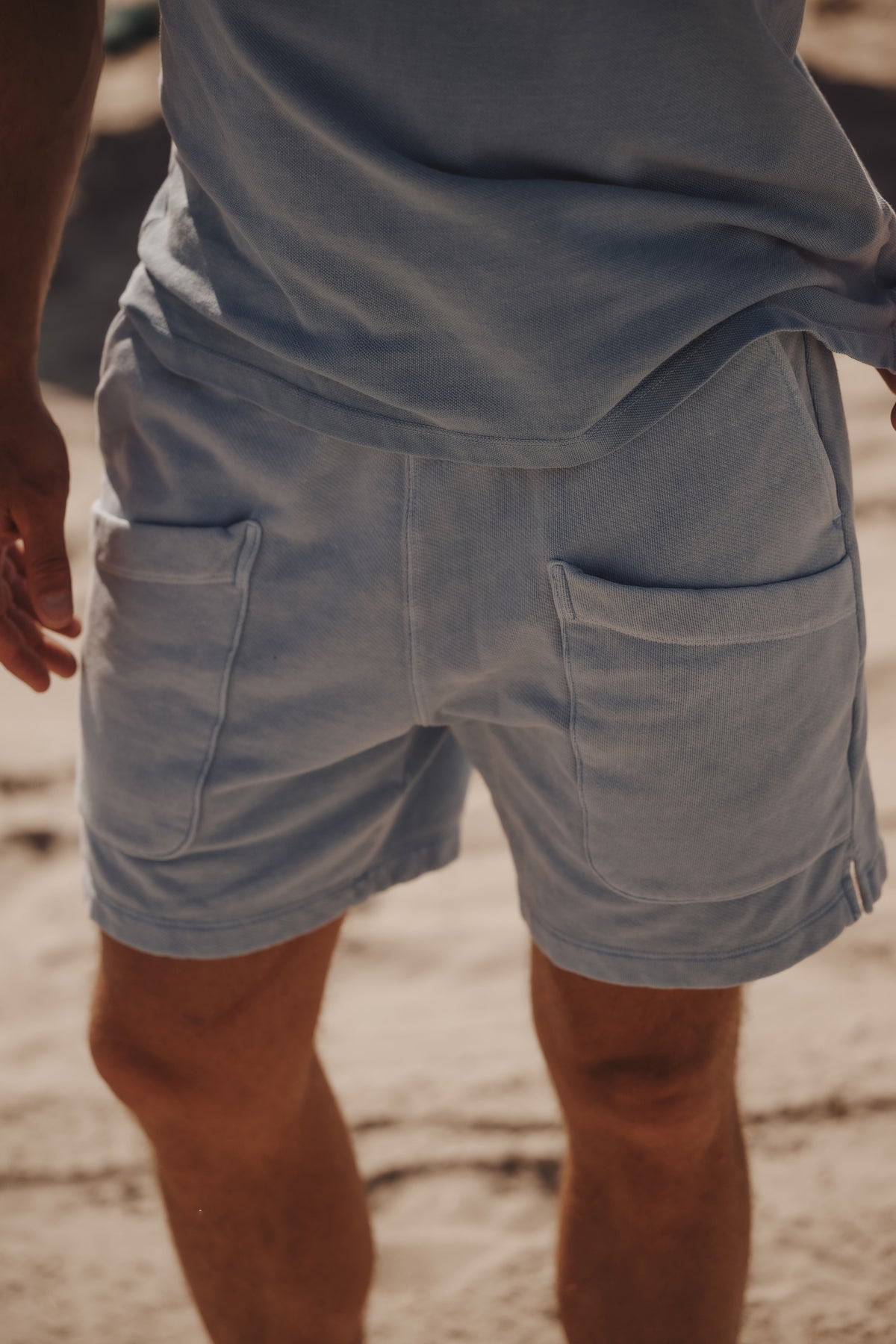 Men's fleece shorts in medium slate blue, front patch pockets, side hem vent detail