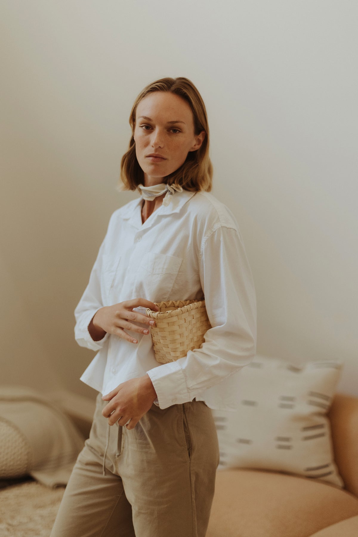 White boxy Oxford shirt with button front and pointed collar, chest patch pockets visible