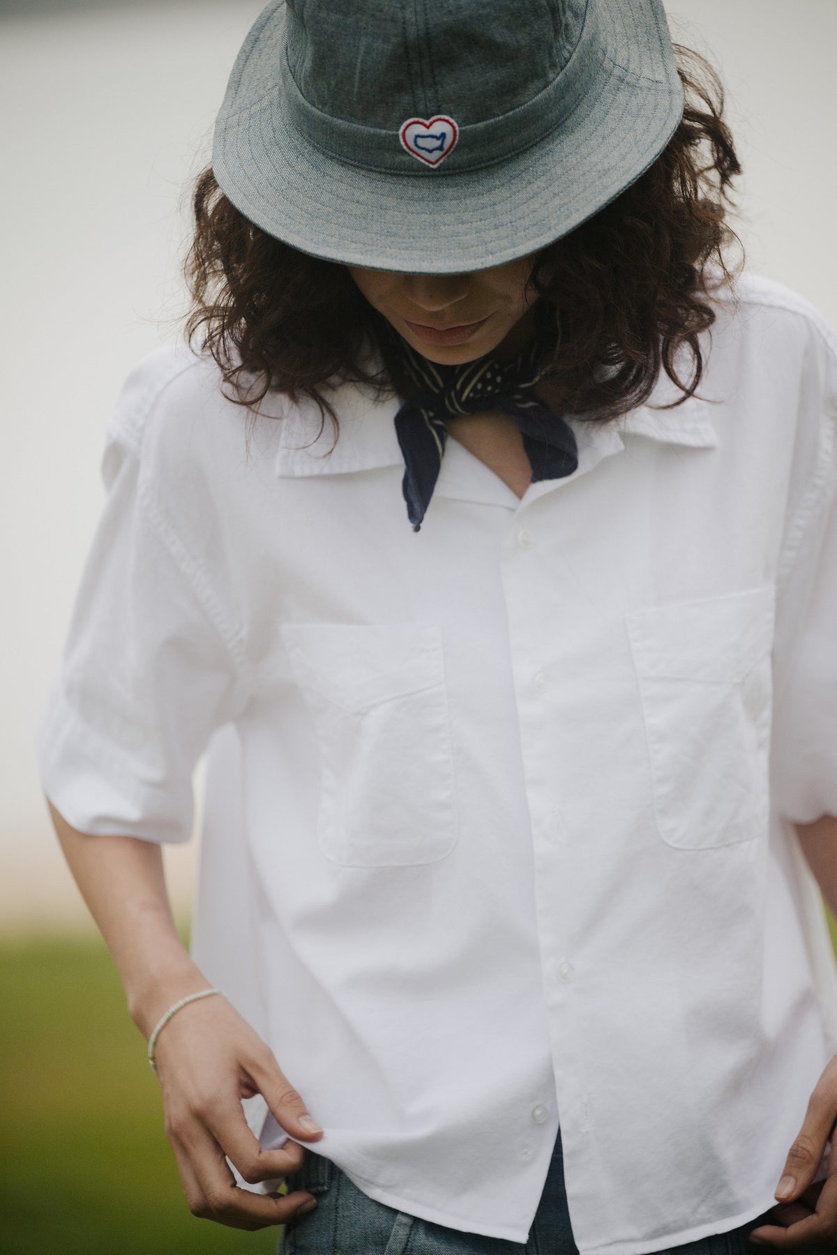 White short-sleeve button-up oxford shirt on model, with pointed collar