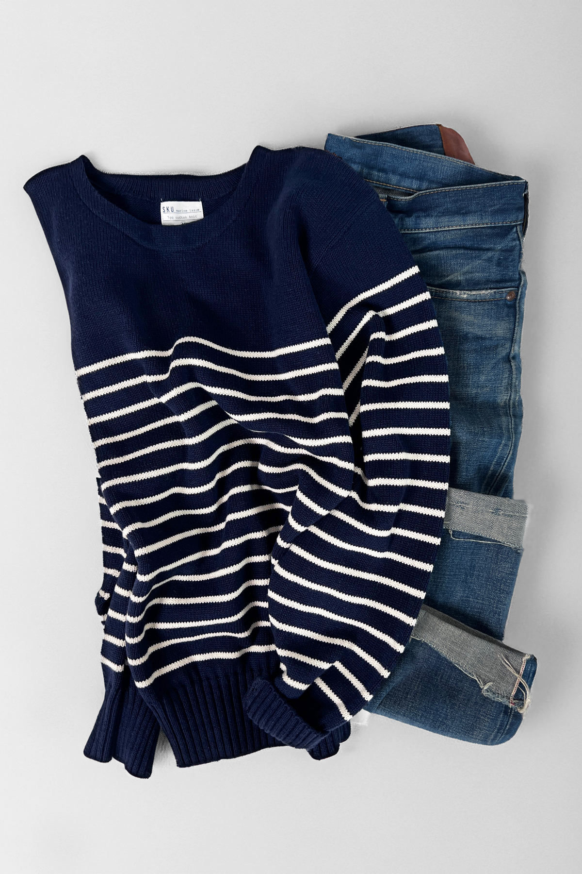 Navy crewneck sweater with white horizontal stripe knit and ribbed hem