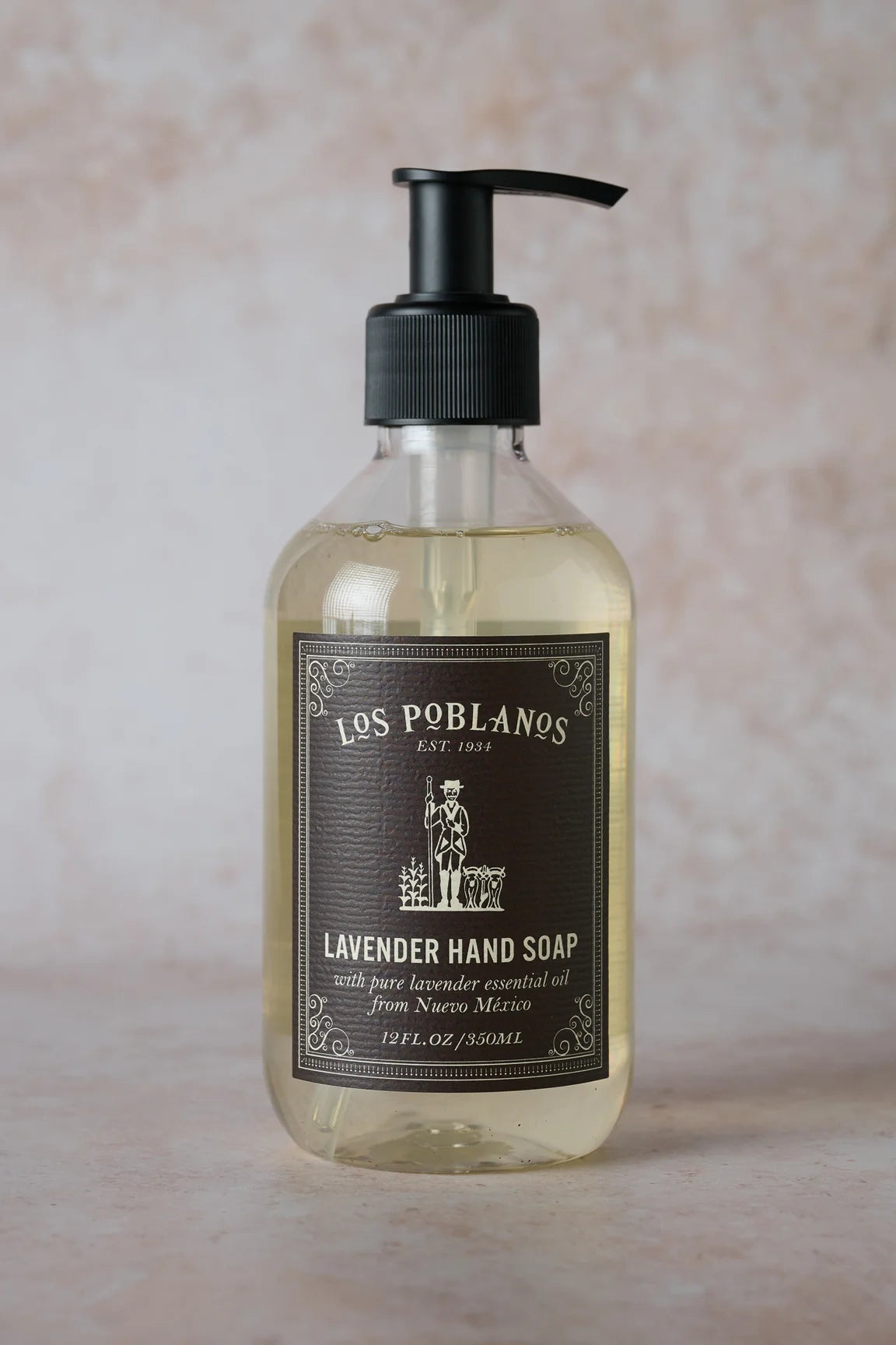 Lavender hand soap bottle with clear glass body and black pump dispenser