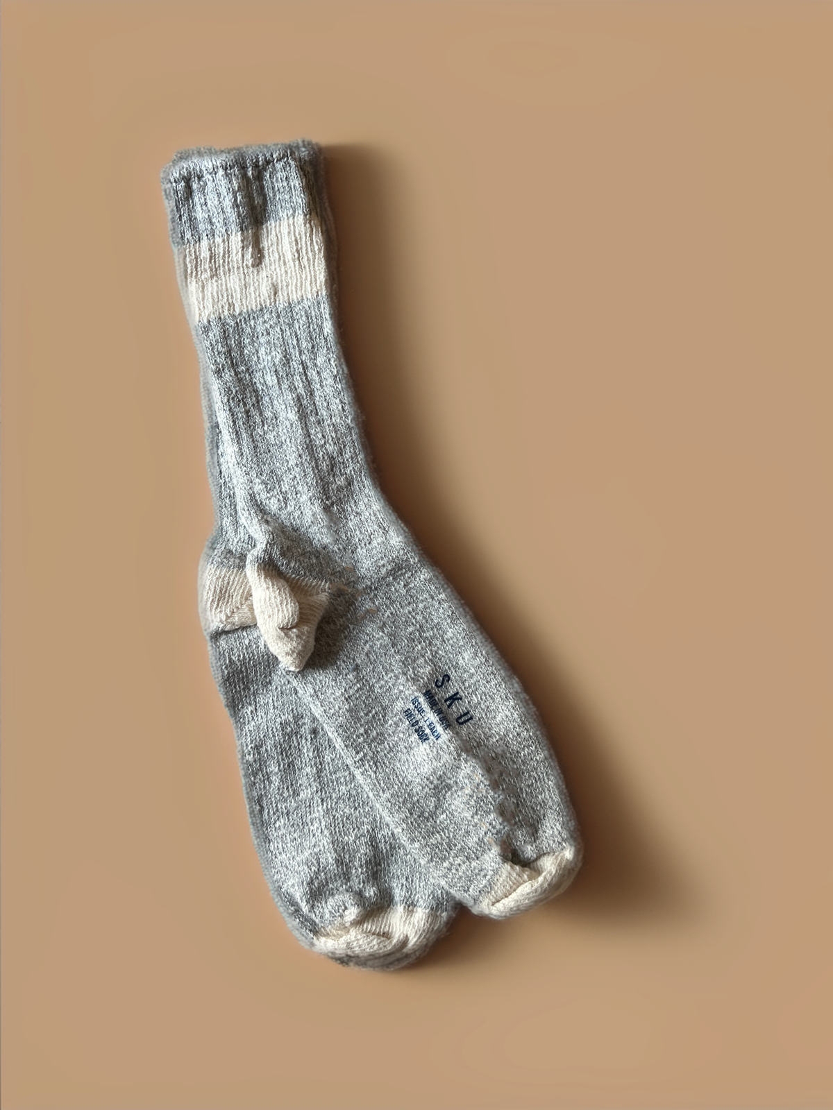 Light grey crew socks with darker heel, toe, and reinforced foot pattern