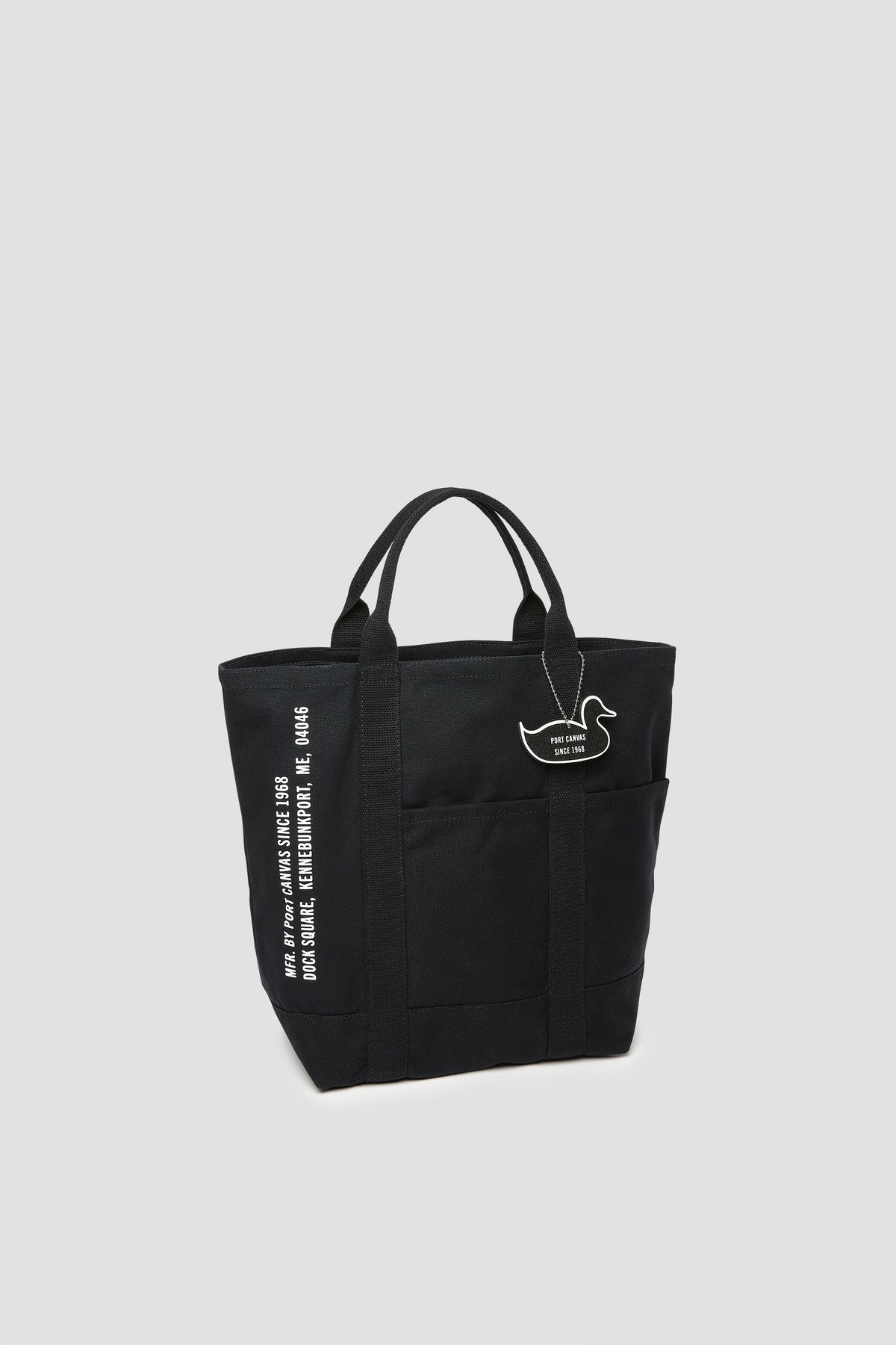 Black canvas tote with cat patch and vertical white lettering on side