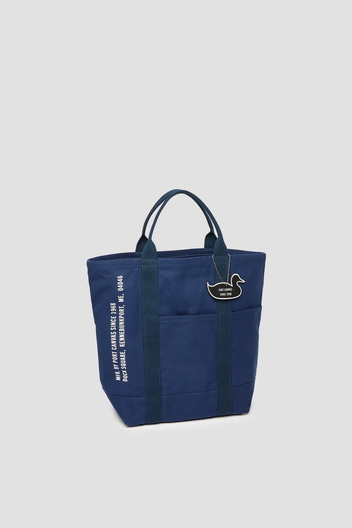 Navy canvas tote with cat patch and vertical white lettering on side