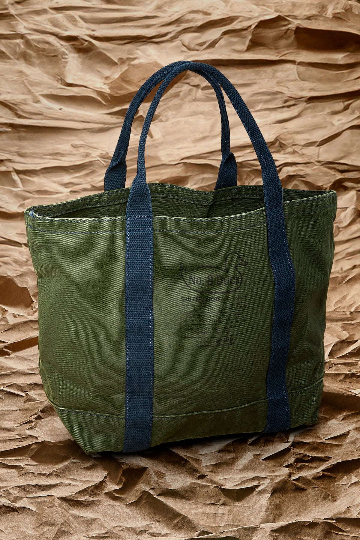 Olive green tote bag with blue handles and front “No. 8 Duck” patch