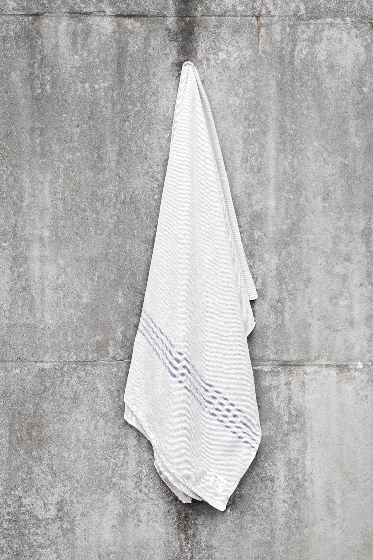 Camp Kennebunk blanket, light gray with blue striped border, folded