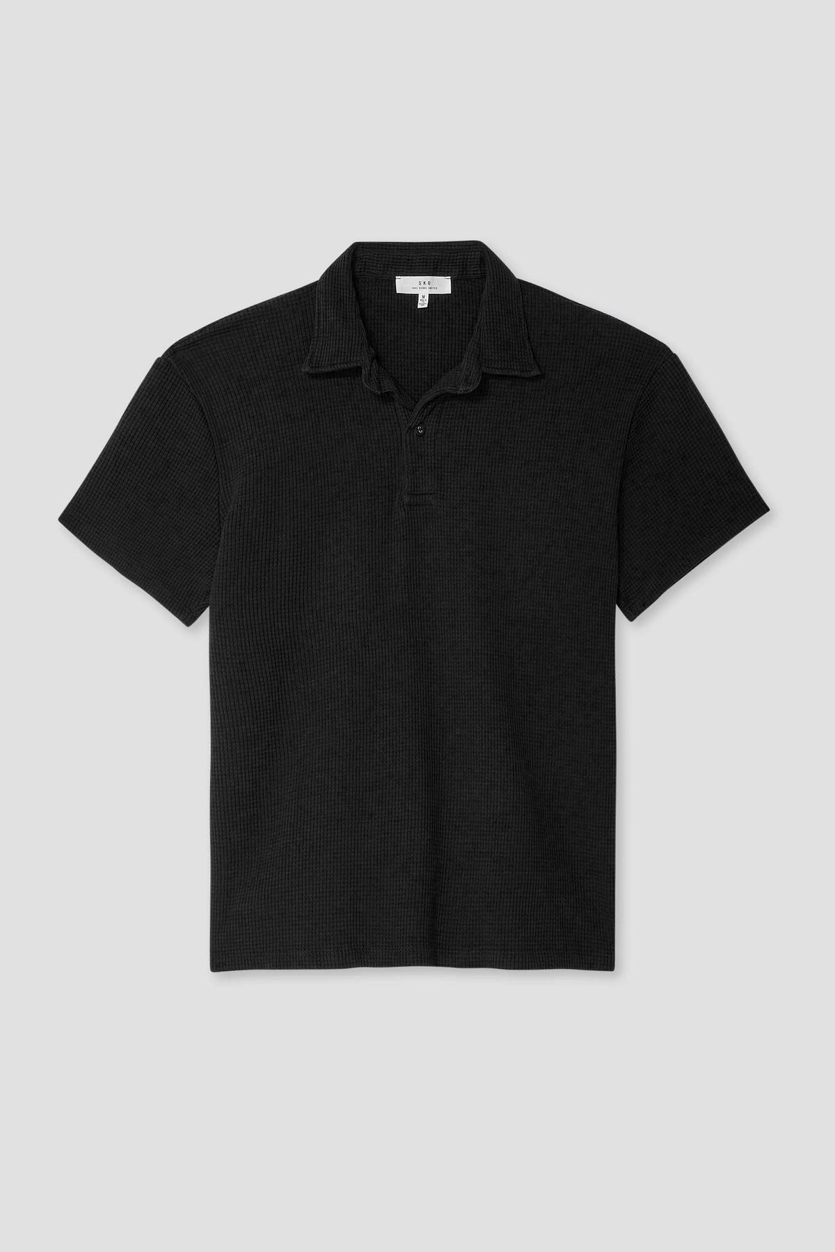 Black waffle polo shirt with short sleeves, collar, and button placket.