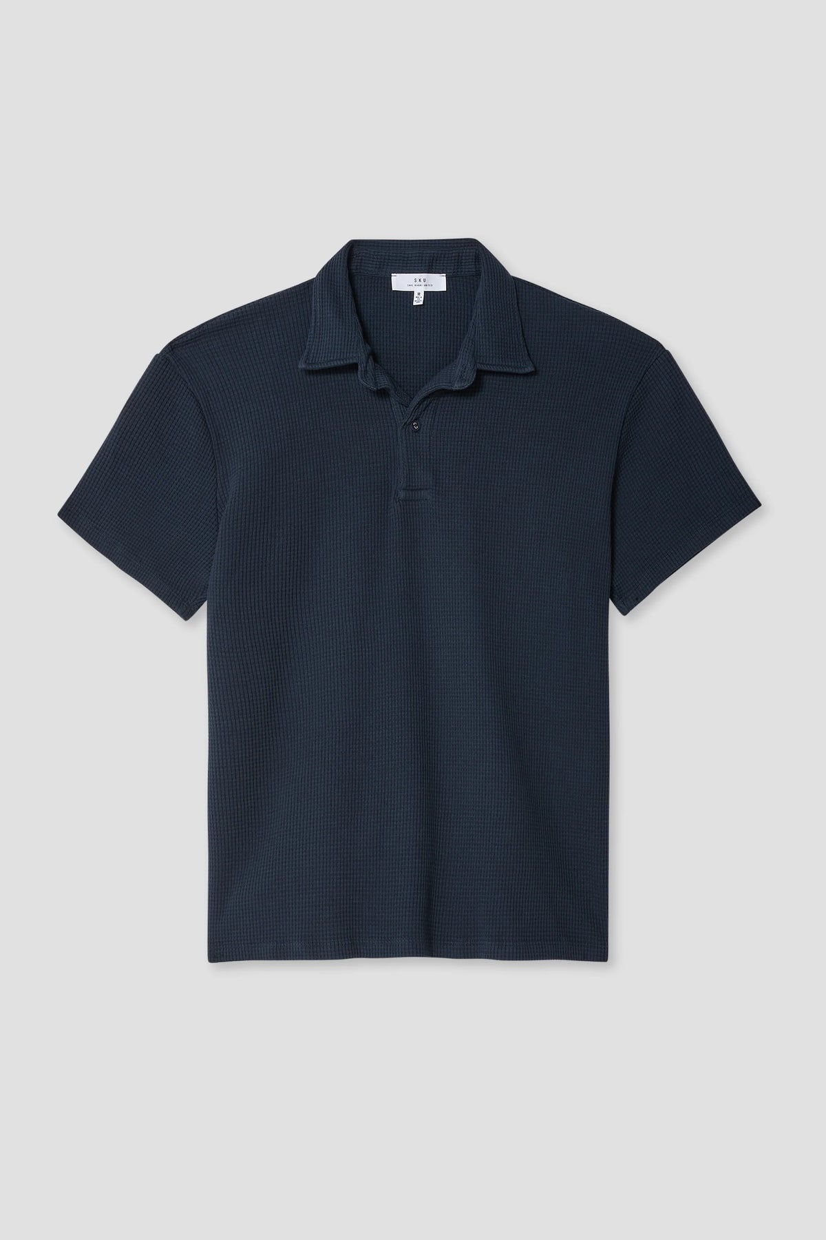 Navy waffle polo shirt with short sleeves, collar, and button placket.