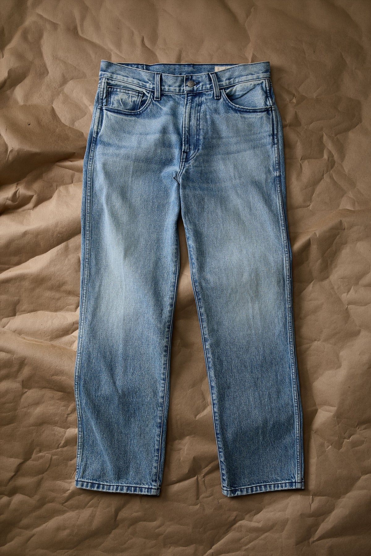 Front view of light blue denim jeans, flat lay