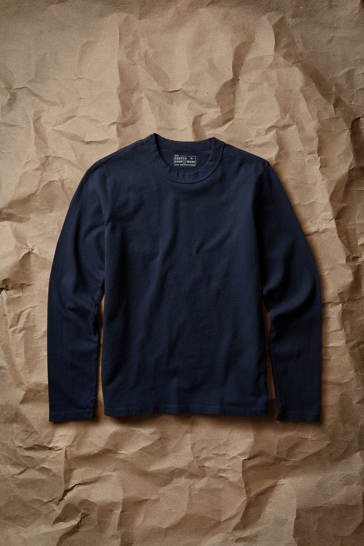 Navy long-sleeve layer tee with crew neck and ribbed collar, laid flat front view