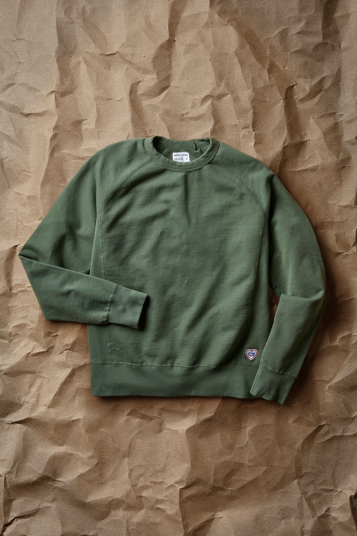 Green crew neck terry sweatshirt with long sleeves and small chest logo