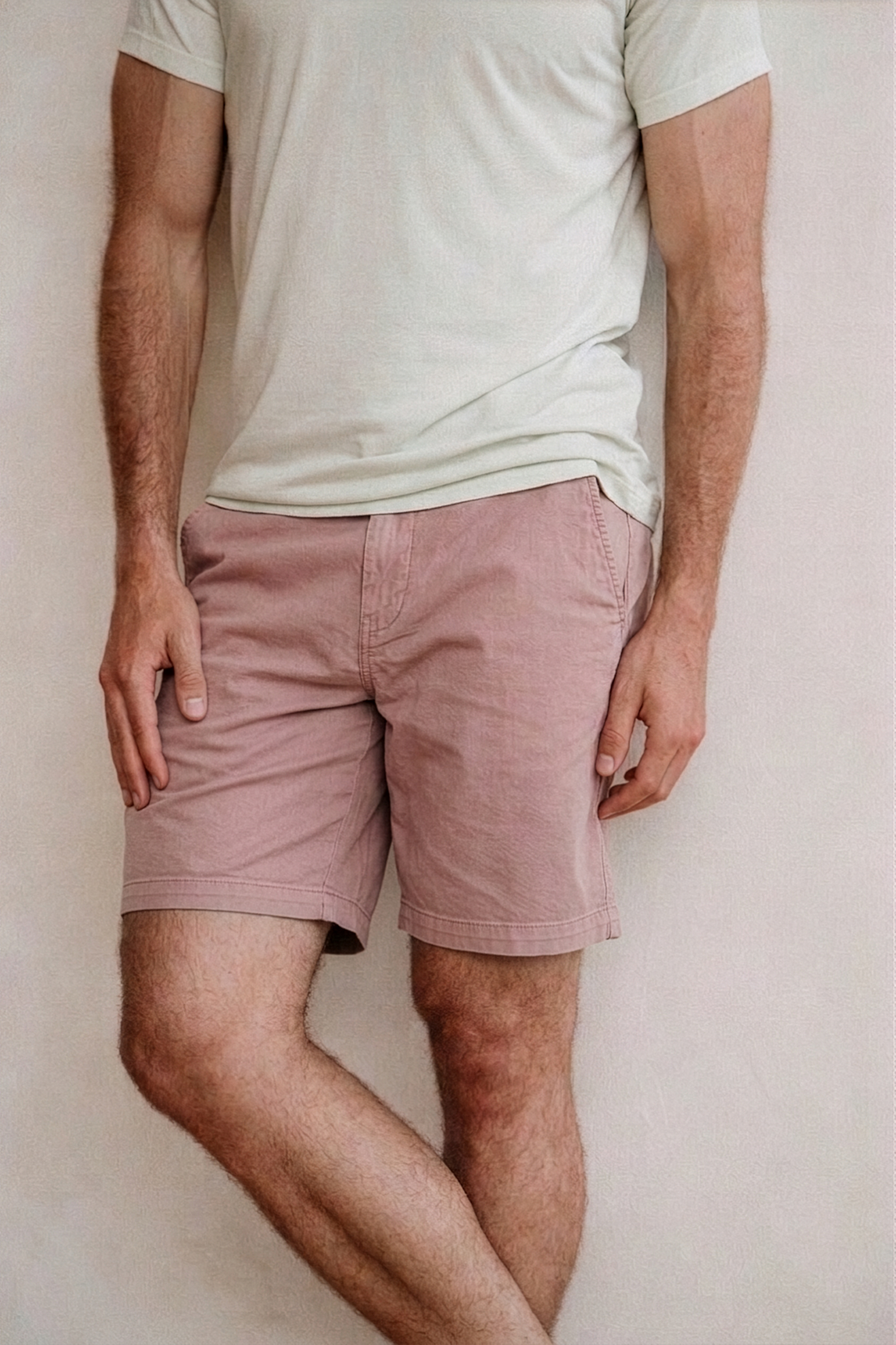 Cotton-hemp weekend shorts in dusty pink worn by model; button fly and side pockets