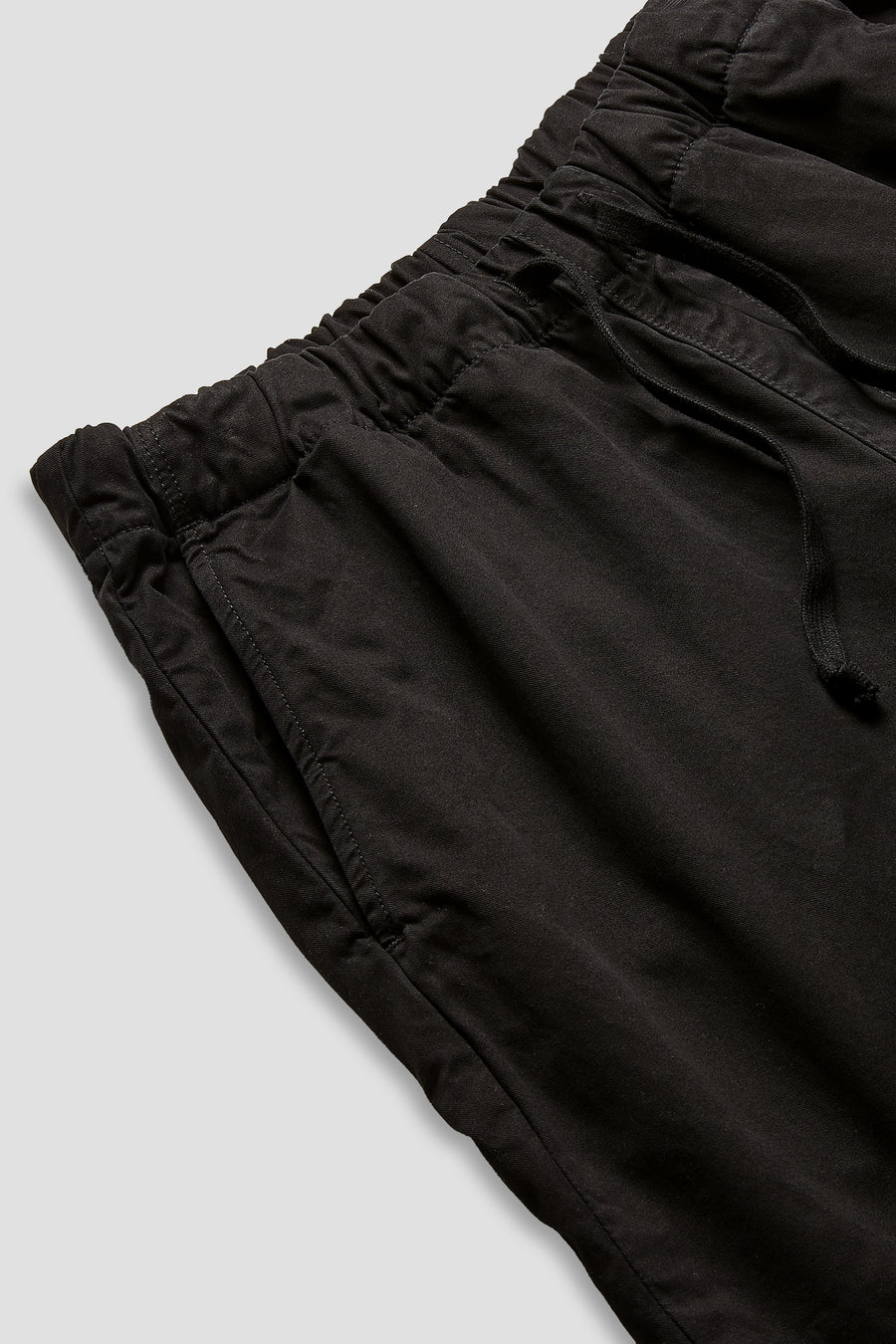 Black twill easy shorts close-up: elastic waistband and side drawcord