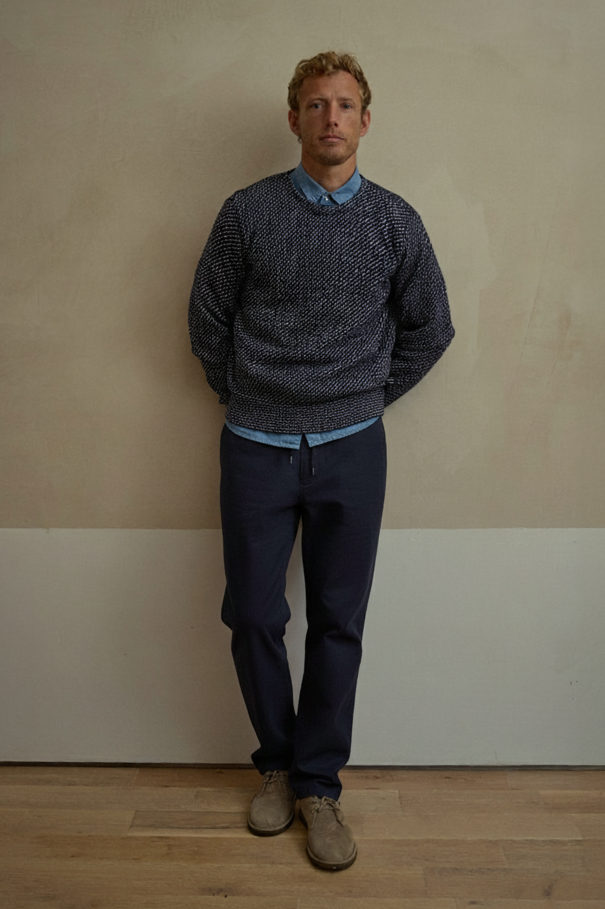 Navy drawstring waist chino pants on model, relaxed tapered legs