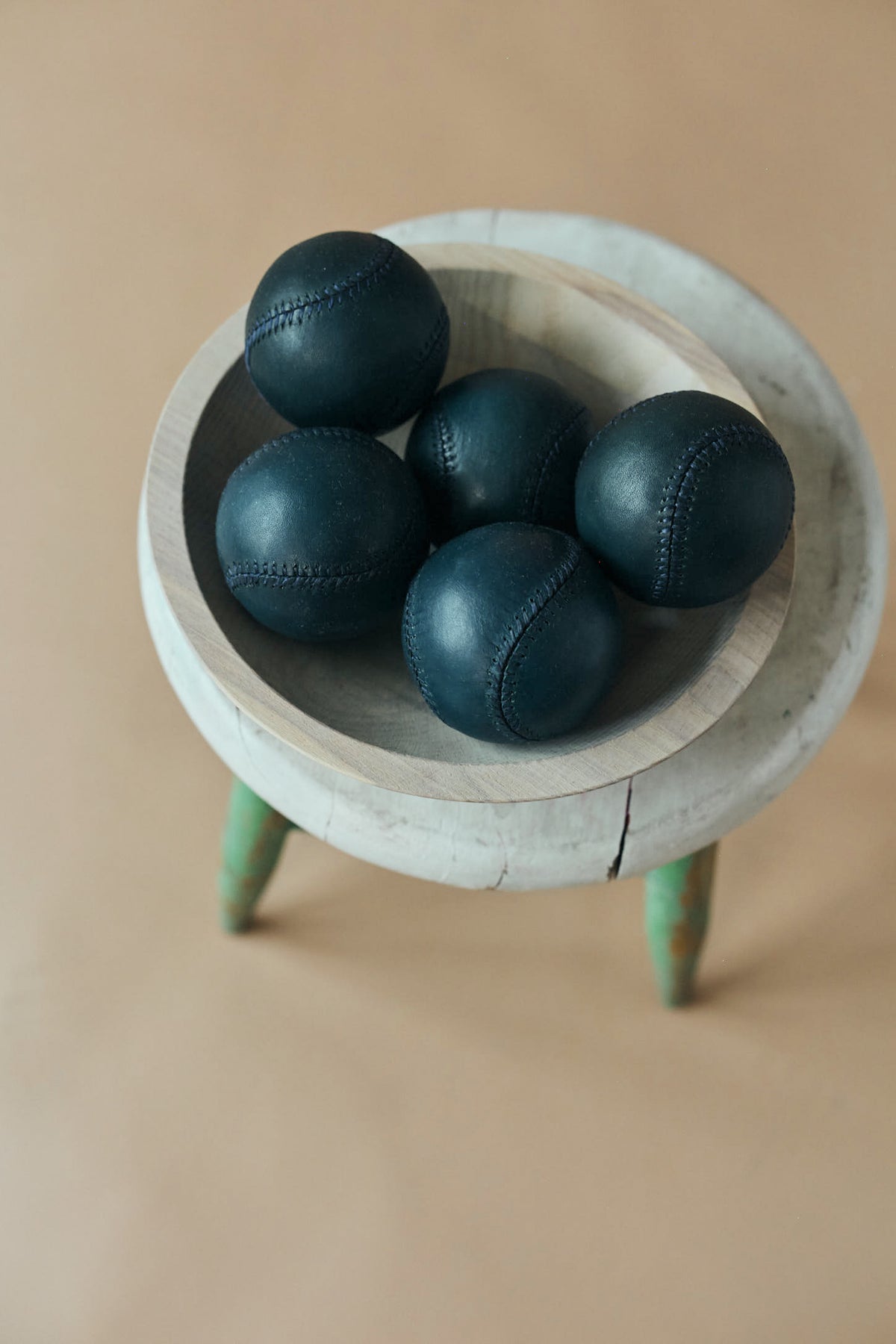 Navy baseballs, five navy balls in a bowl