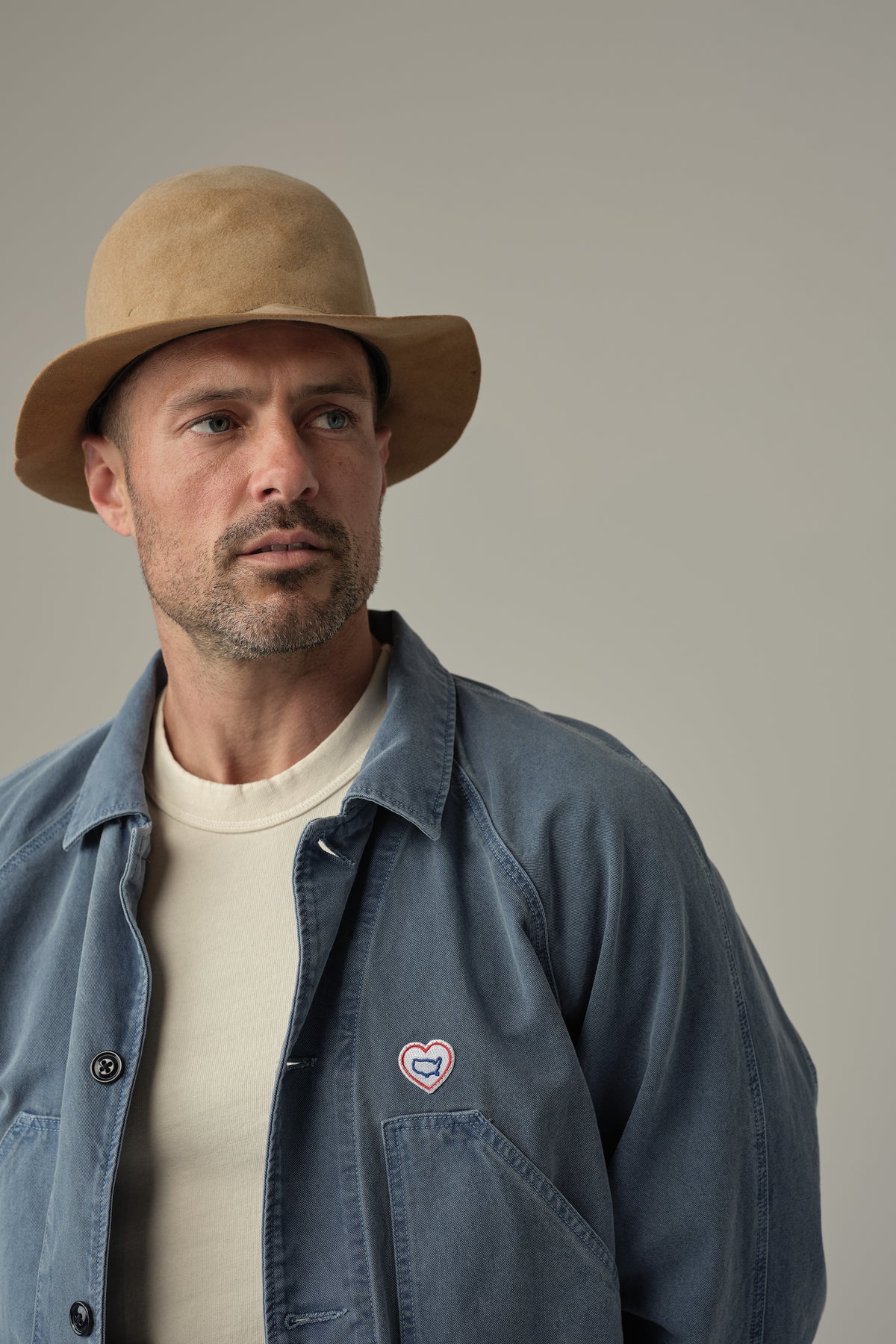 Union blue drill chore jacket with heart chest patch and button-up front