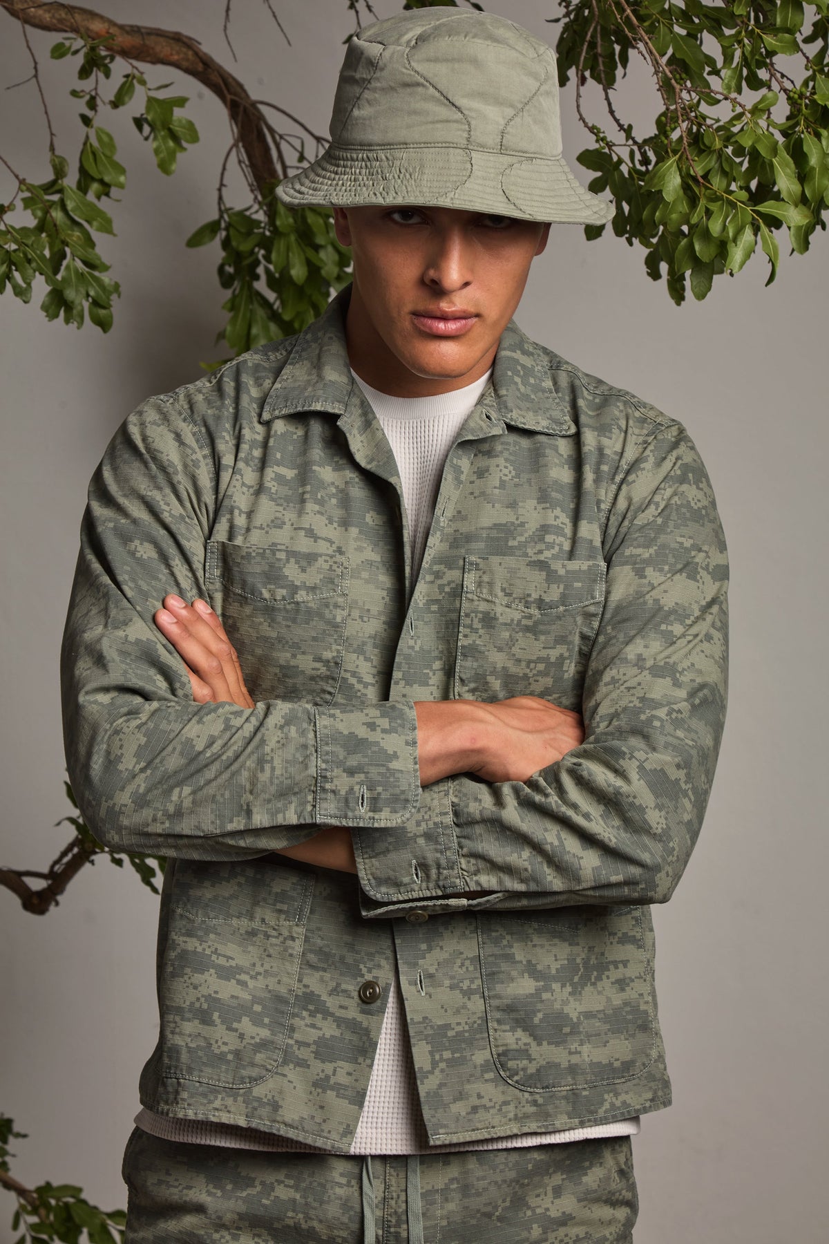 Men's green camouflage shirt jacket with button front, chest pockets, long sleeves