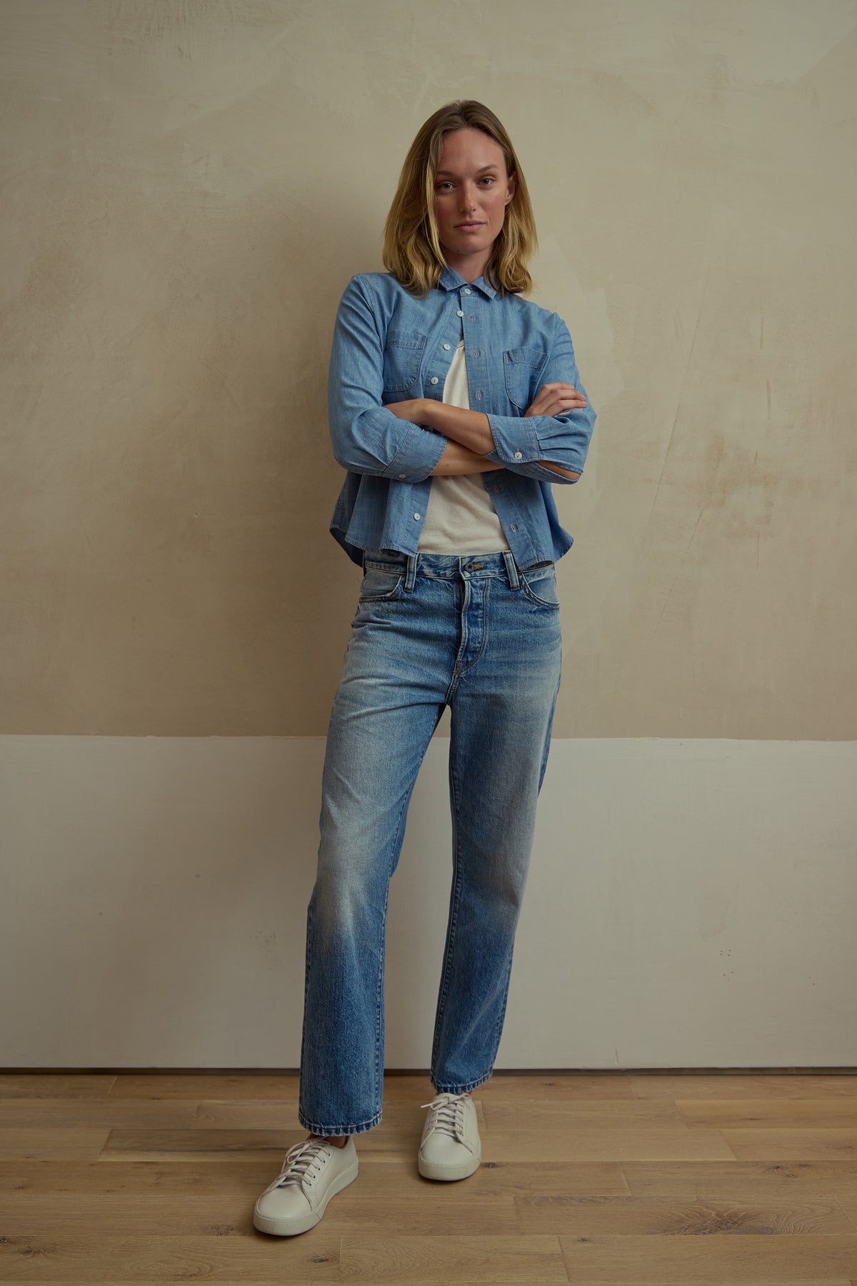 Medium wash blue boyfriend-fit denim jeans with button fly, belt loops, and straight legs