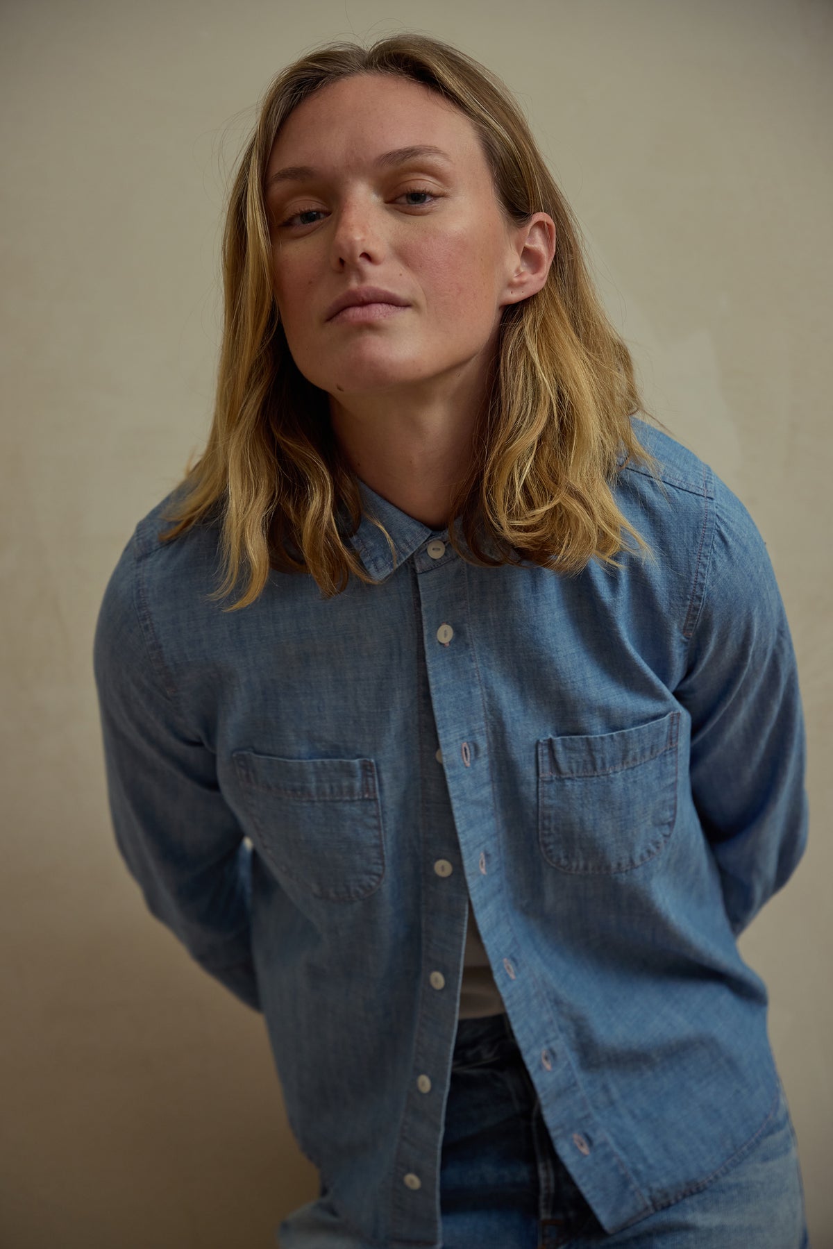 Light blue chambray button-up shirt with chest pockets, front view