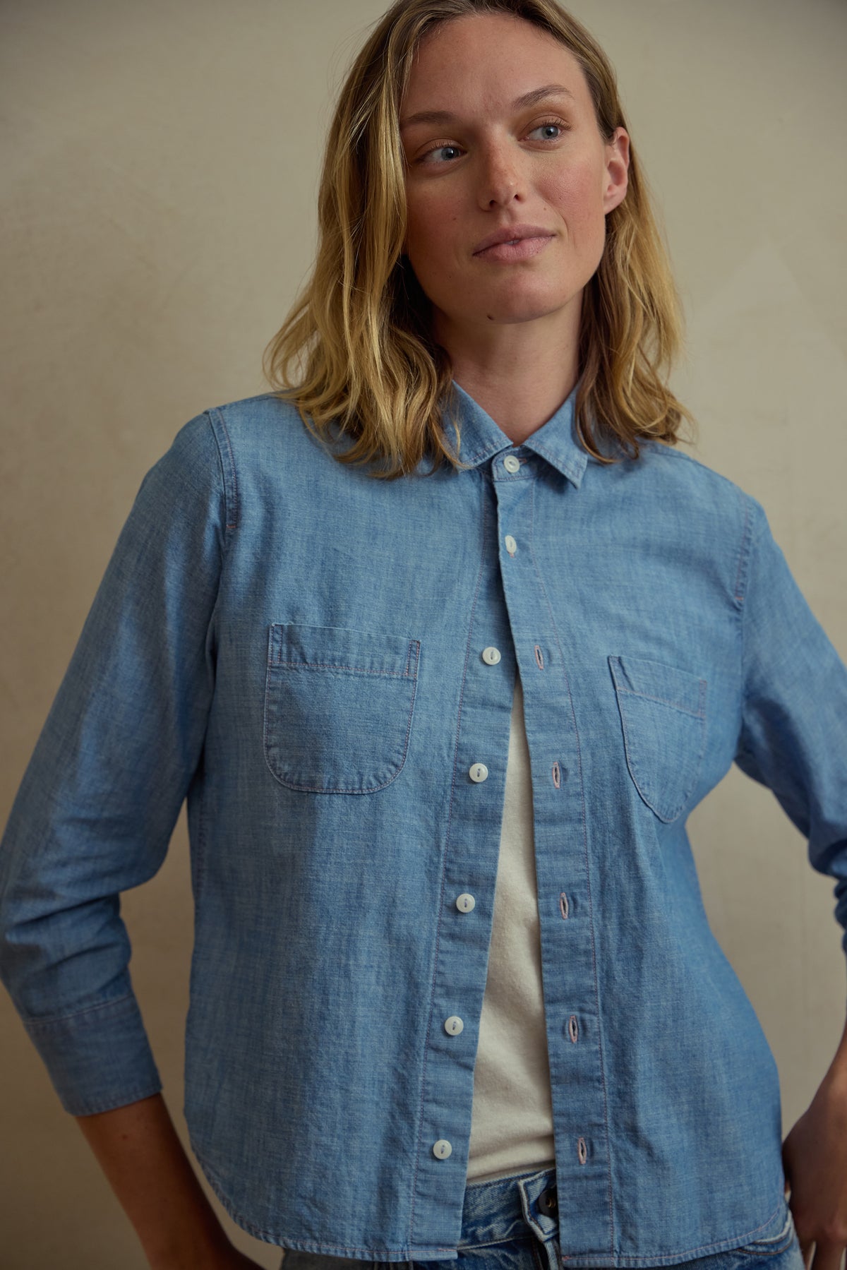 Light blue chambray button-up shirt with stand collar and front button placket