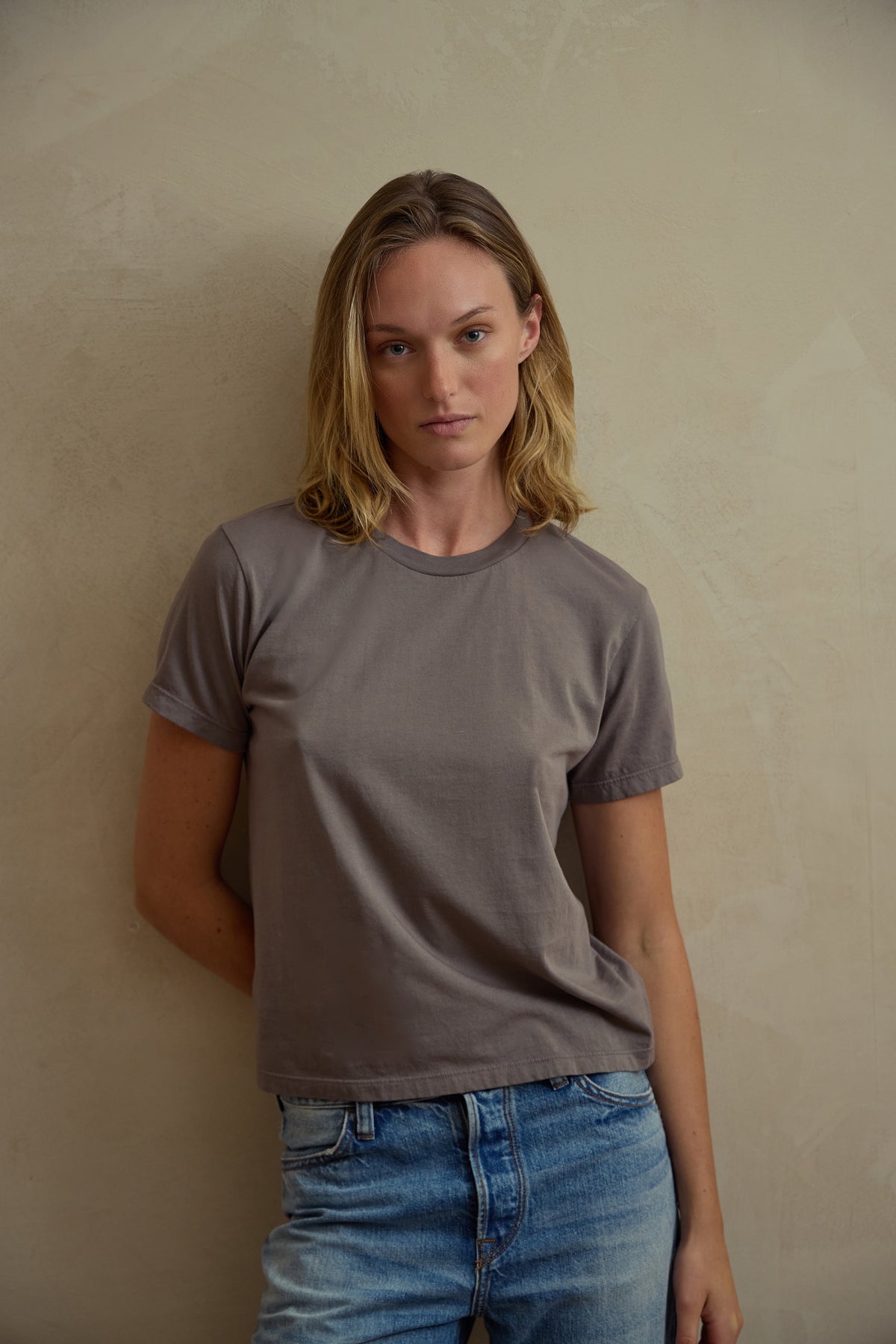 Gray standard crew tee on model, short sleeves and crew neckline