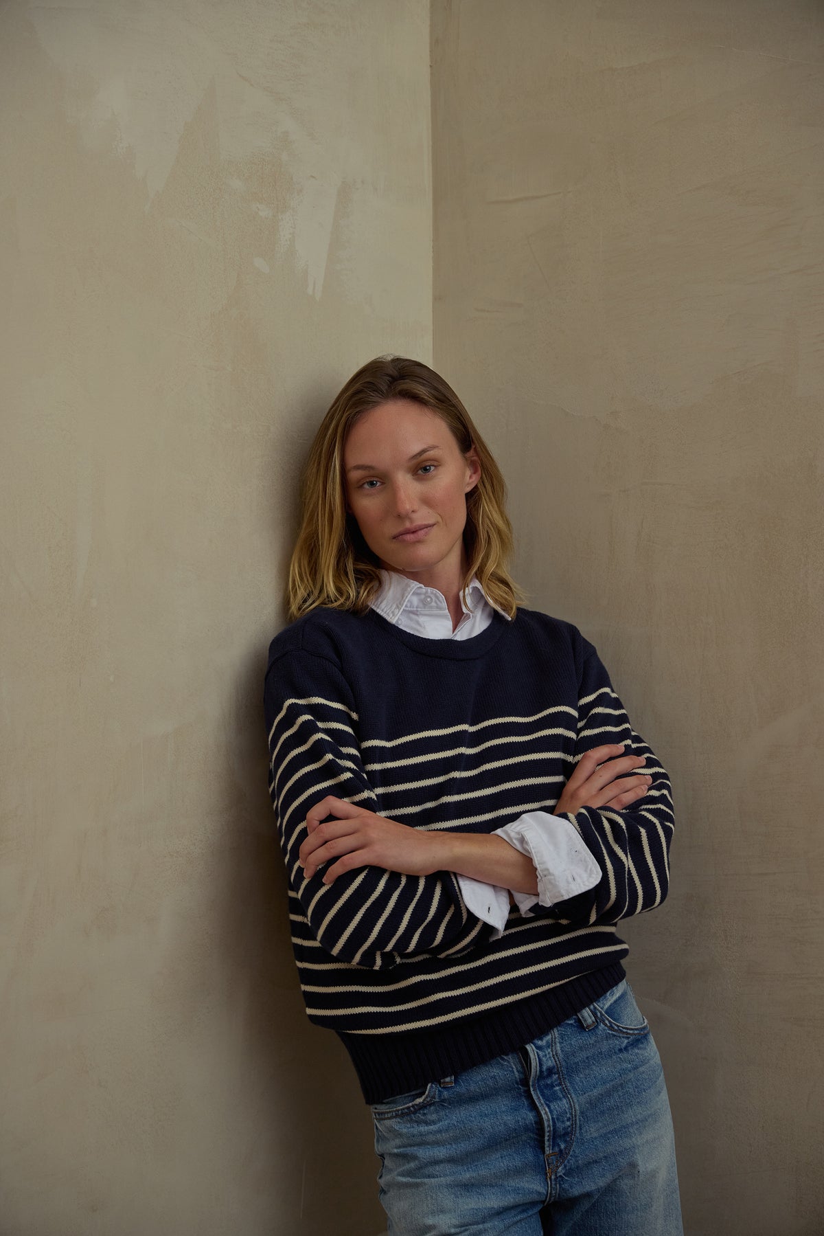 Navy crewneck sweater with white striped ribbed cuffs