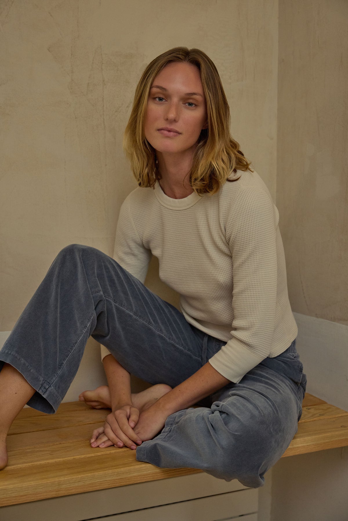 Cream waffle-knit 3/4-sleeve tee on a model, crew neck