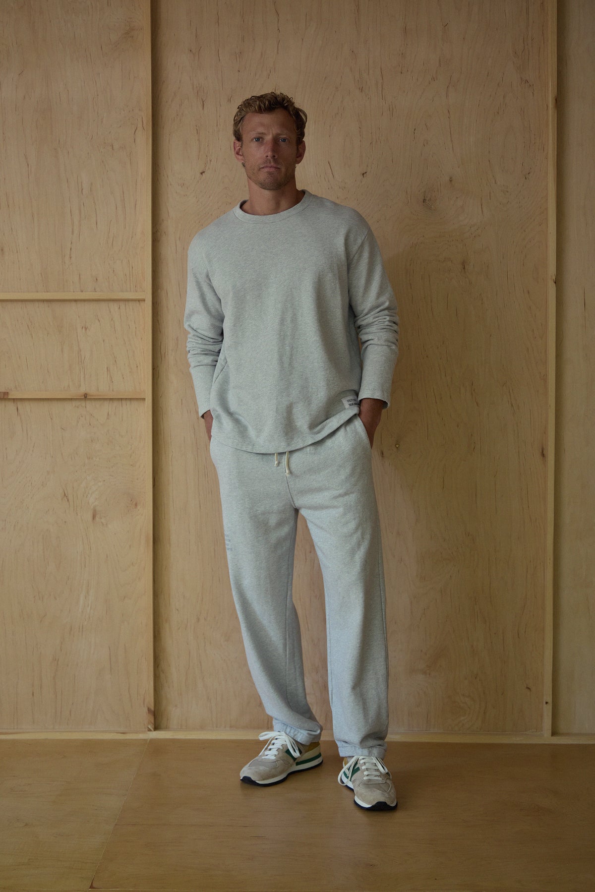 Light gray crewneck terry sweatshirt worn by model with drawstring waist