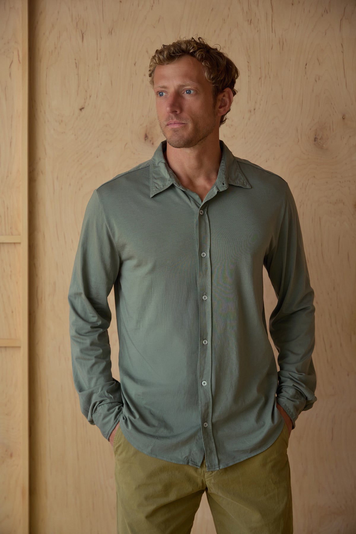 Sage green long-sleeve button-up jersey shirt on model, point collar and front buttons