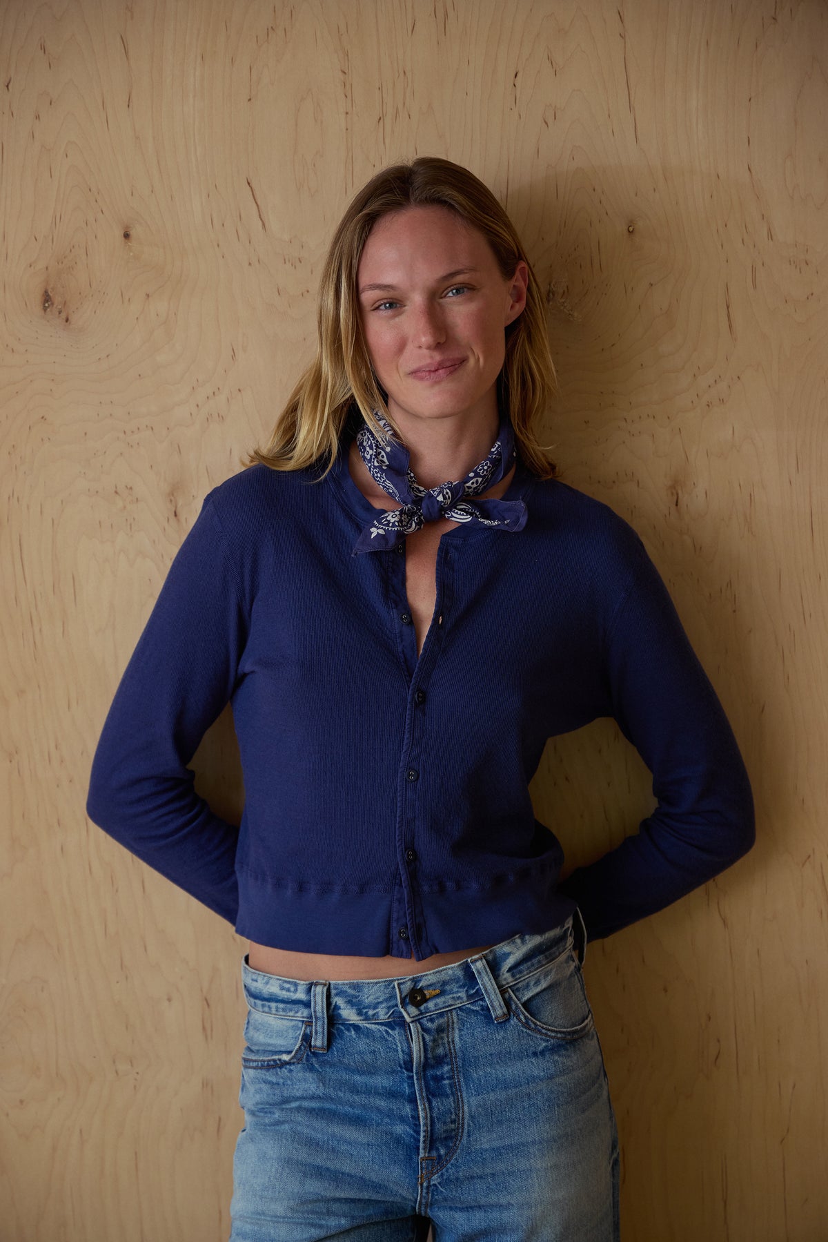 Navy pointelle knit cardigan with button front and long sleeves