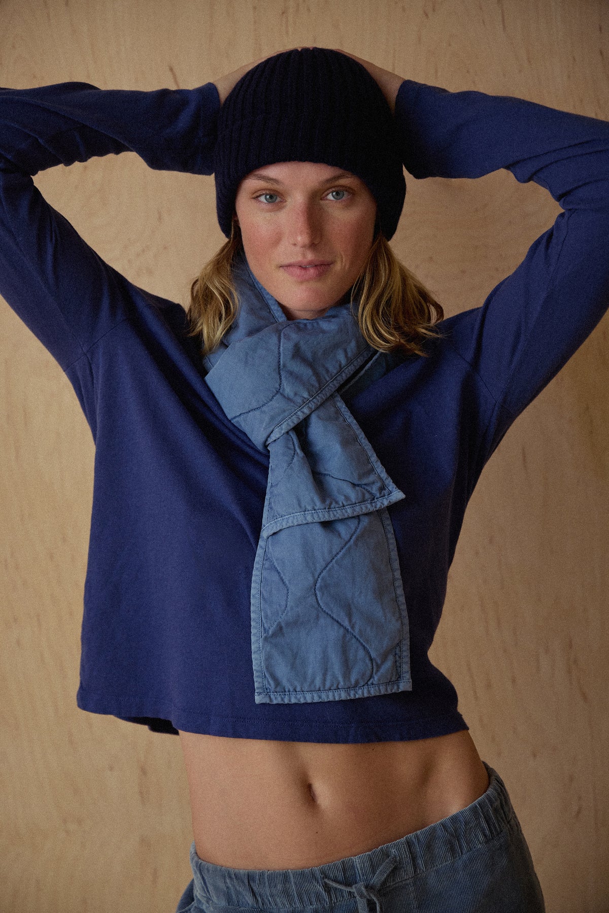 Indigo long-sleeve boy T-shirt with crew neck, worn by model with arms raised