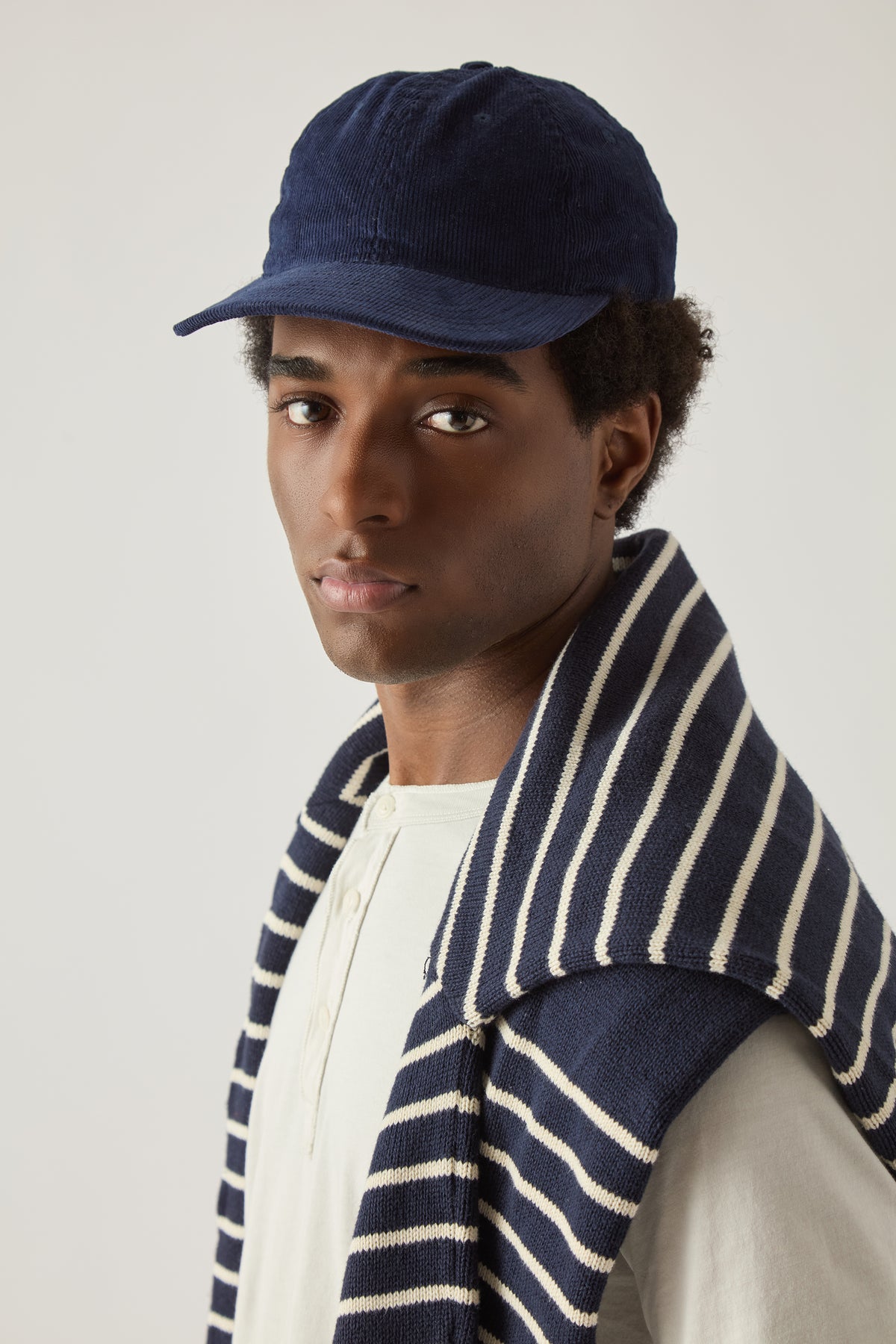Navy corduroy baseball cap with curved brim and adjustable back strap