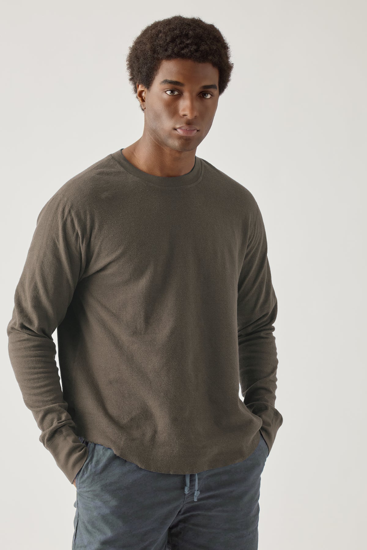 Olive brown long-sleeve crewneck T-shirt worn by a model