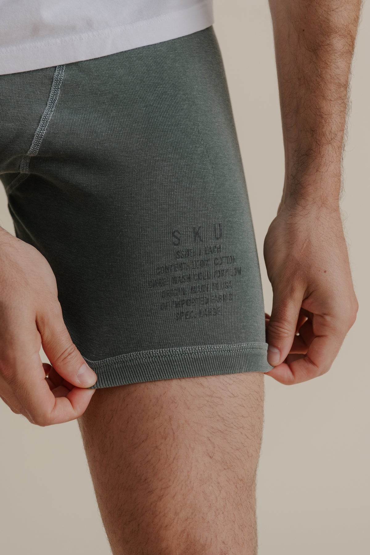 Dark green distressed dye rib boxer briefs on model, hem label visible