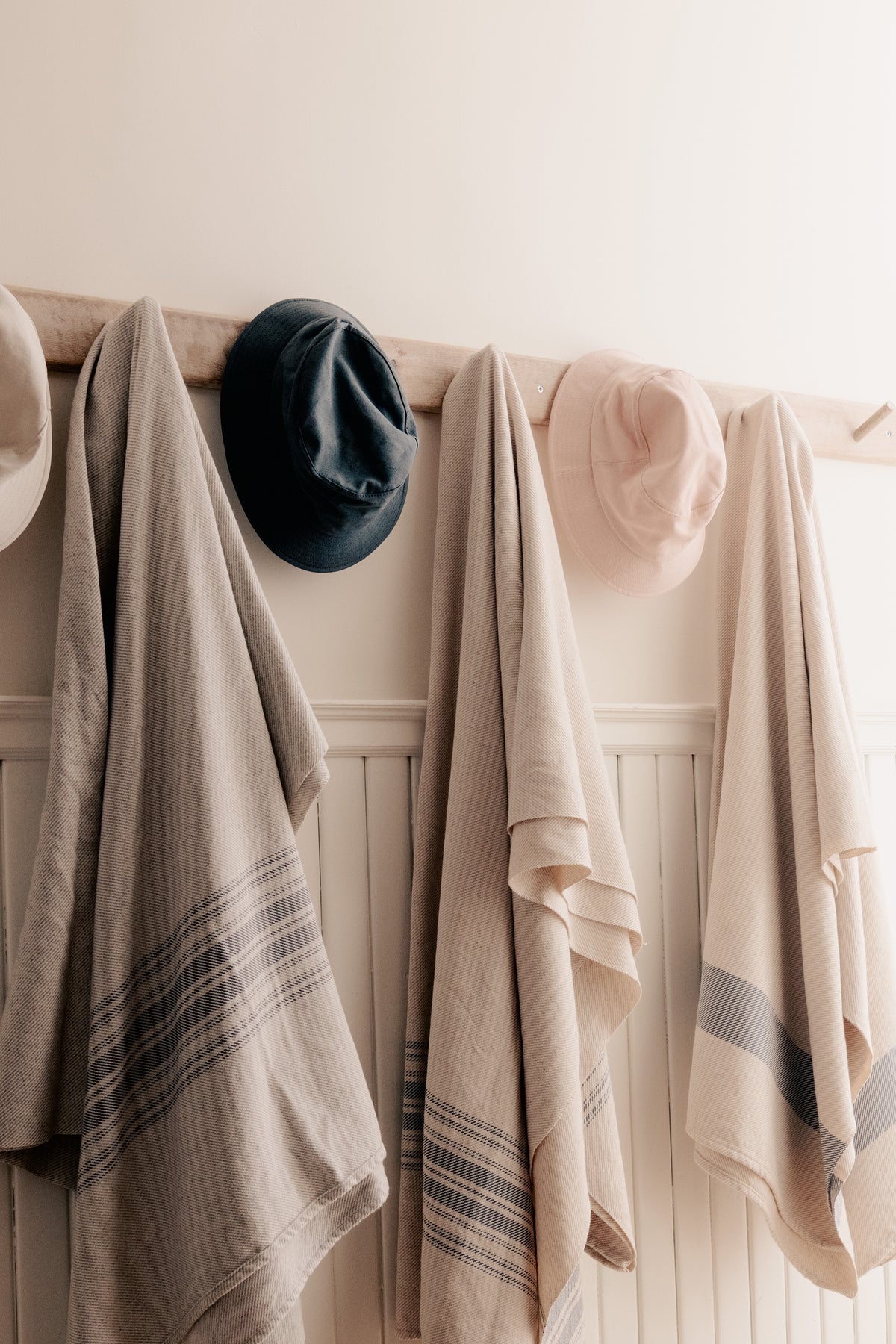 Striped woven blanket in oat and denim, hemmed edges