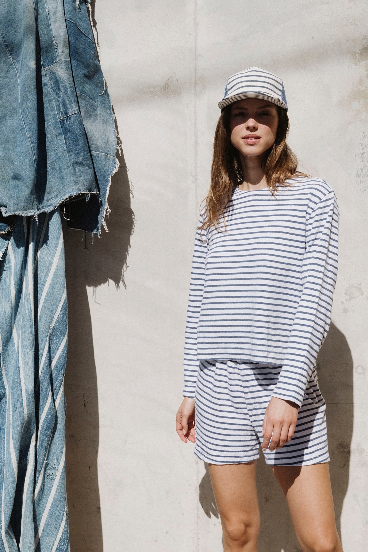 Blue and white striped shorts with elastic waistband, side view