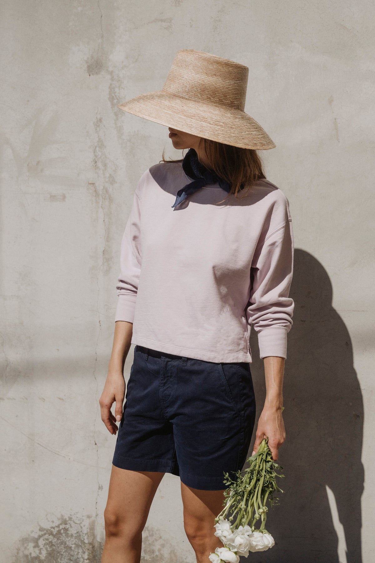 Light pink cropped fleece sweatshirt, three-quarter view with long sleeves