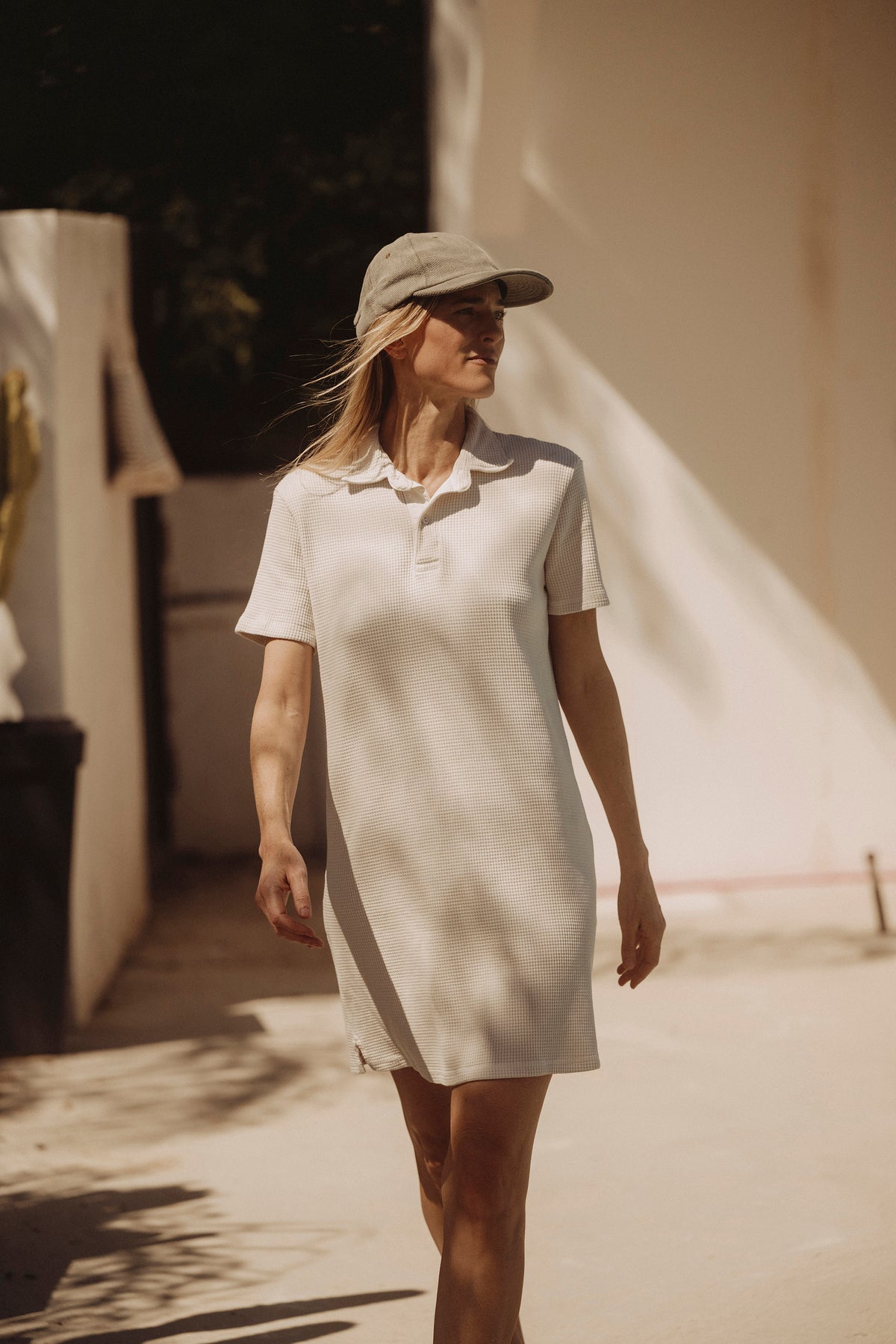 Light cream waffle polo dress on model, short sleeves and pointed collar