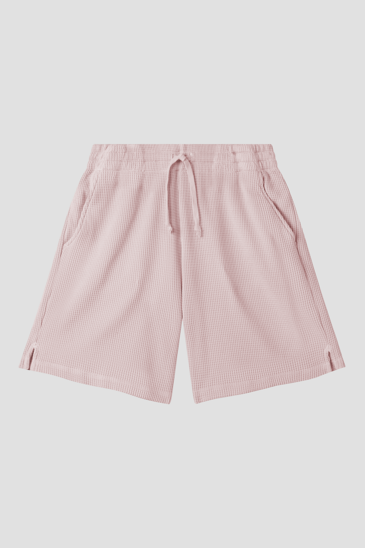 Pale pink waffle-knit shorts with elastic drawstring waist and side pockets
