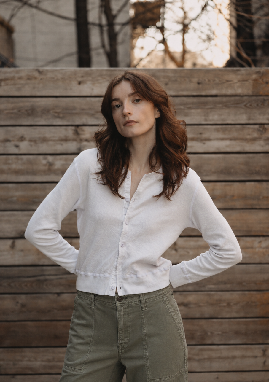 White pointelle knit cardigan with button front and long sleeves