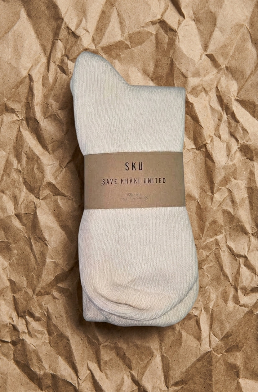 Crew socks in light gray/white with ribbed knit and banded brand label